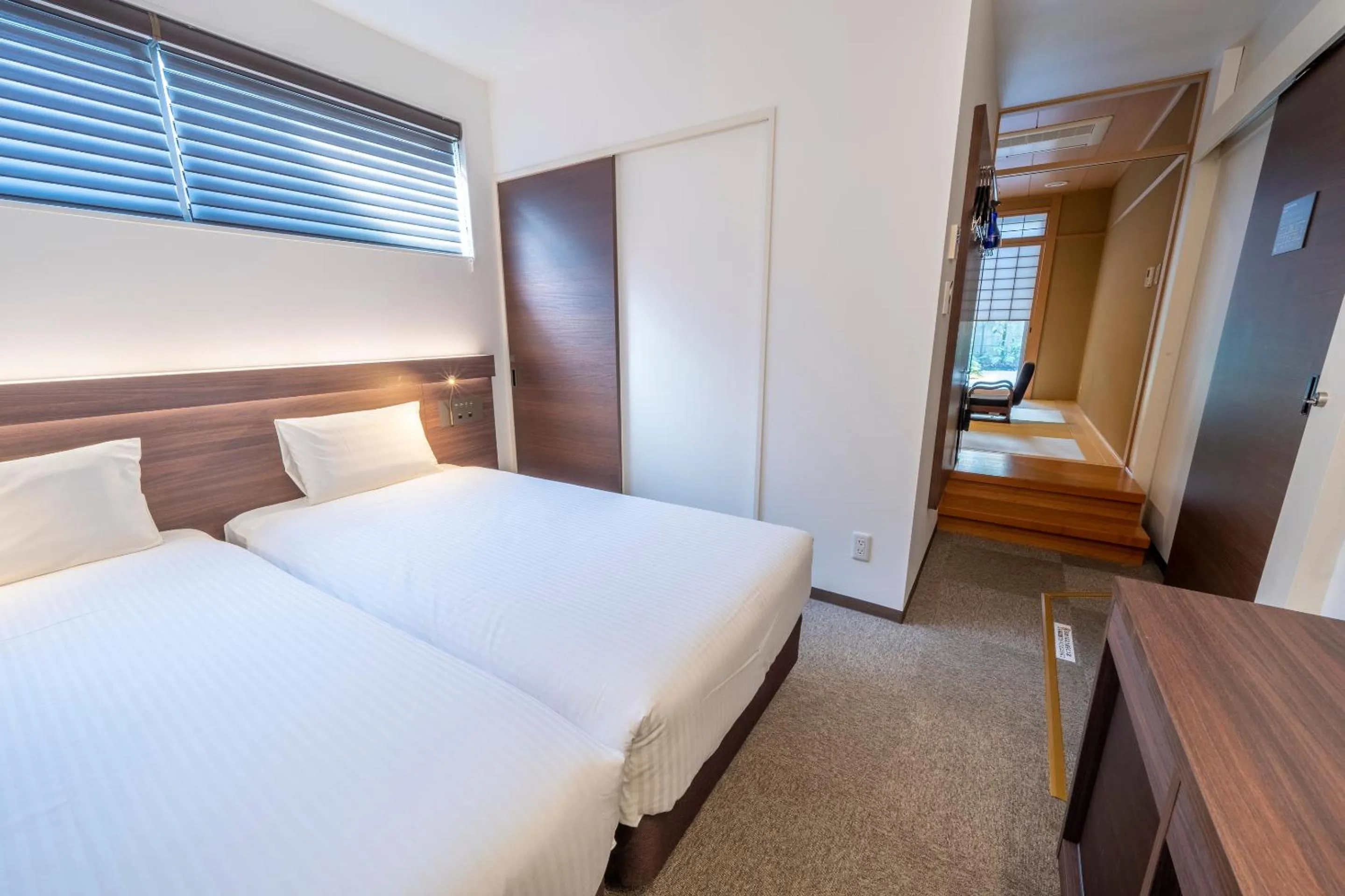 Bed in RESI STAY Jisco Hotel Kyoto Goshonishi