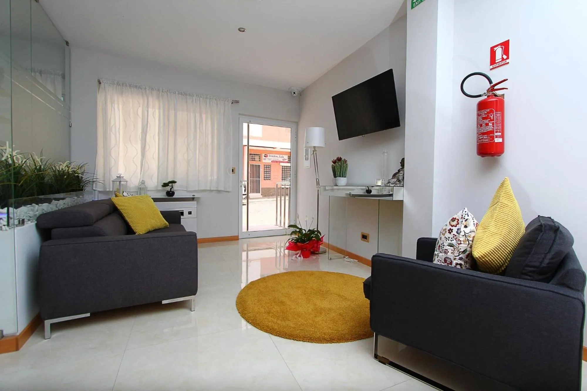 Communal lounge/ TV room in Morenos Boutique Hotel