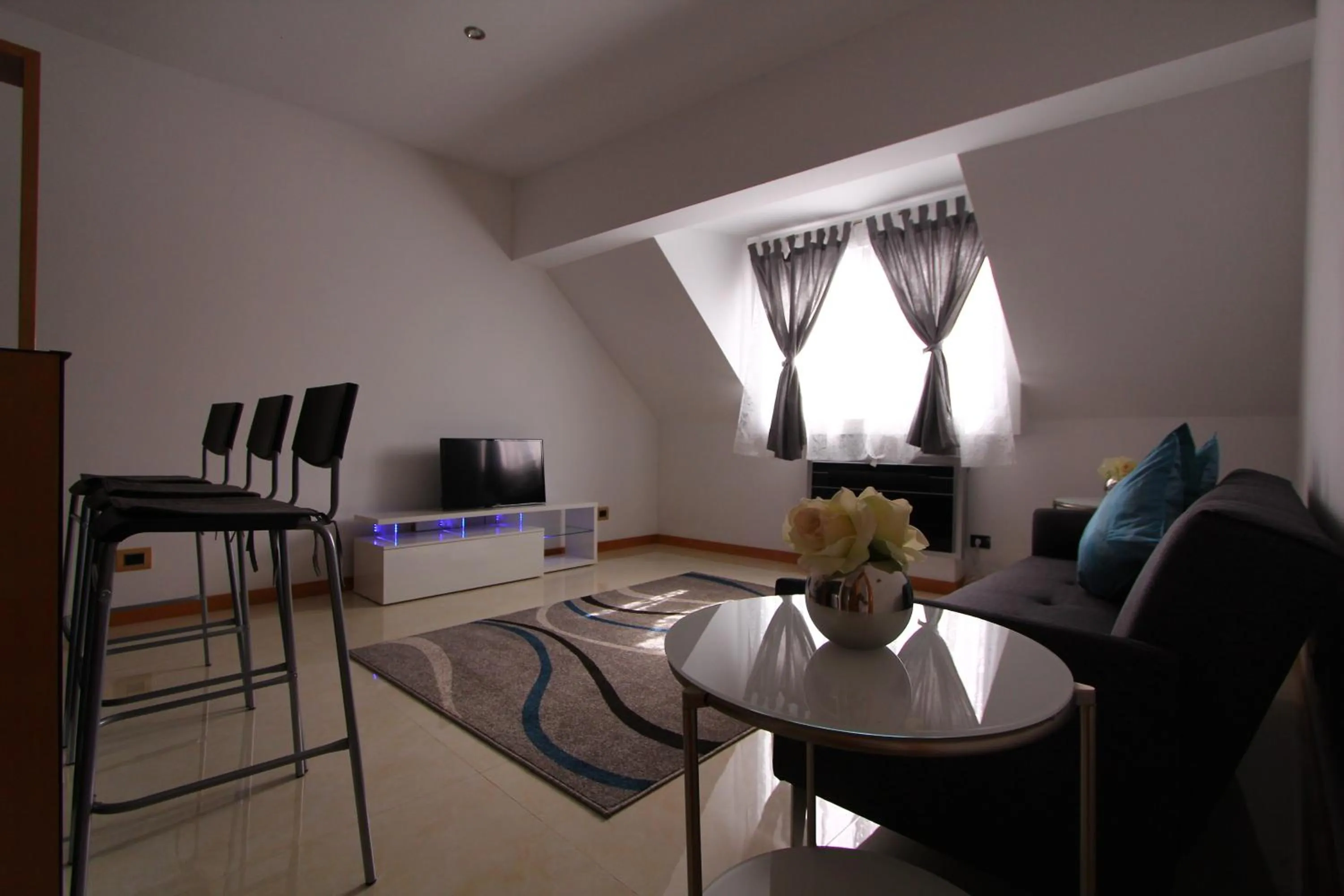 Communal lounge/ TV room in Morenos Boutique Hotel