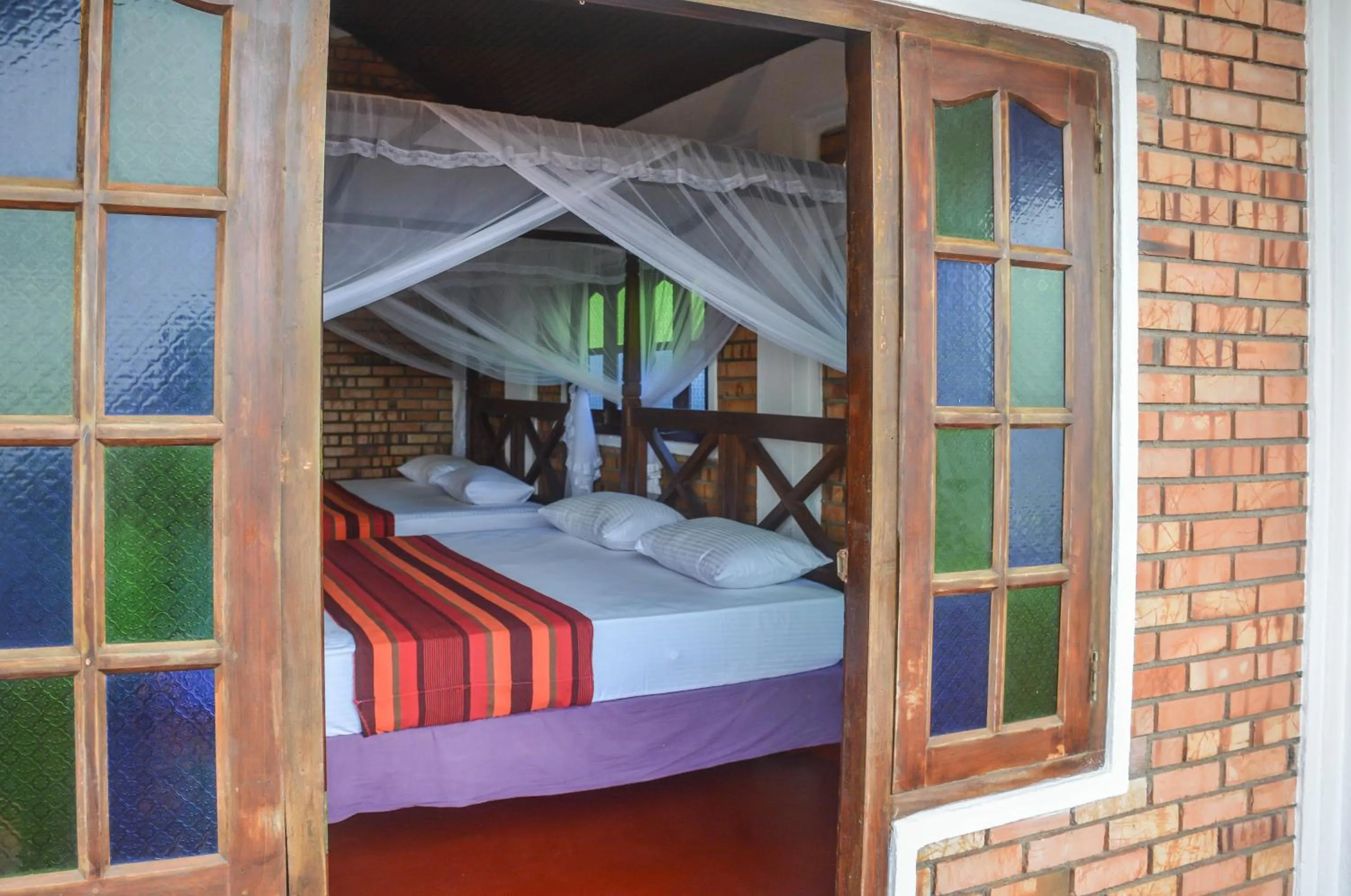 Bed in Blue Horizon Beach Hotel