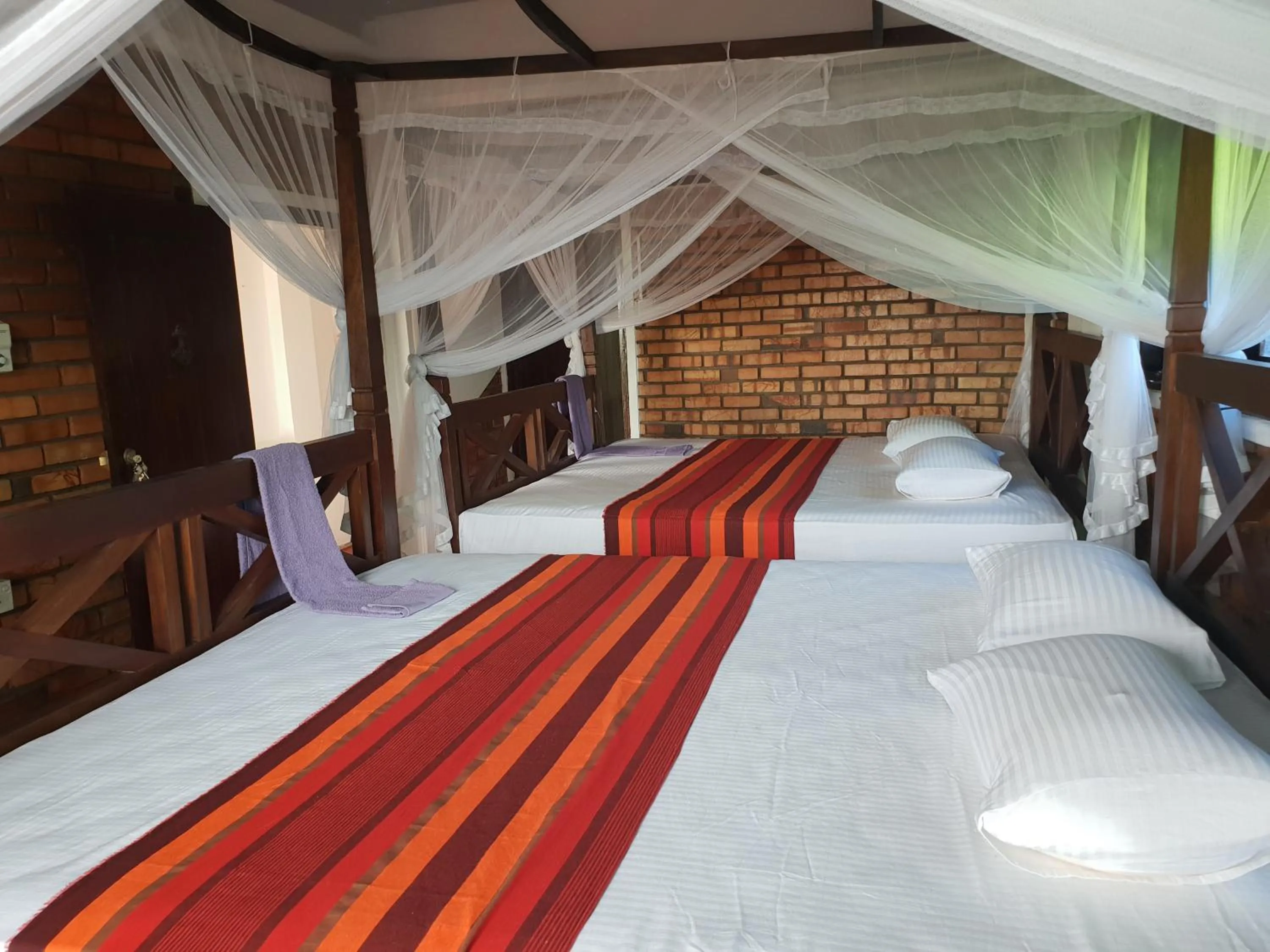 Bed in Blue Horizon Beach Hotel