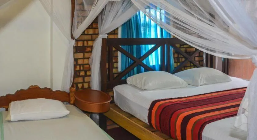 Bed in Blue Horizon Beach Hotel