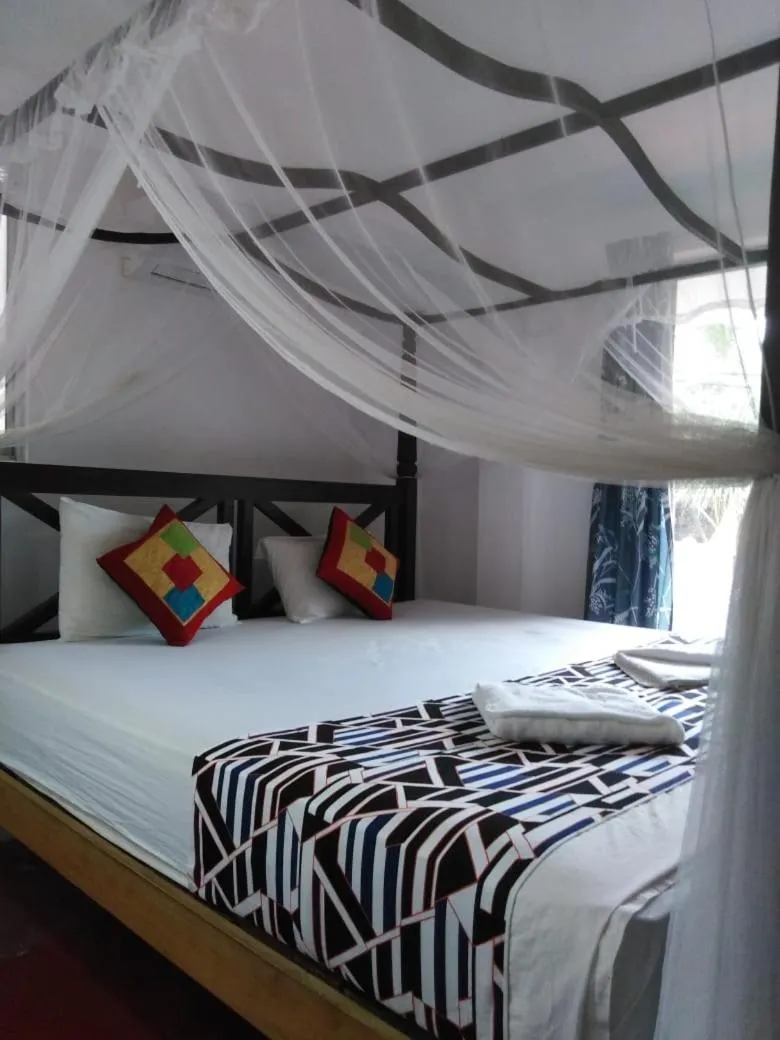 Bed in Blue Horizon Beach Hotel