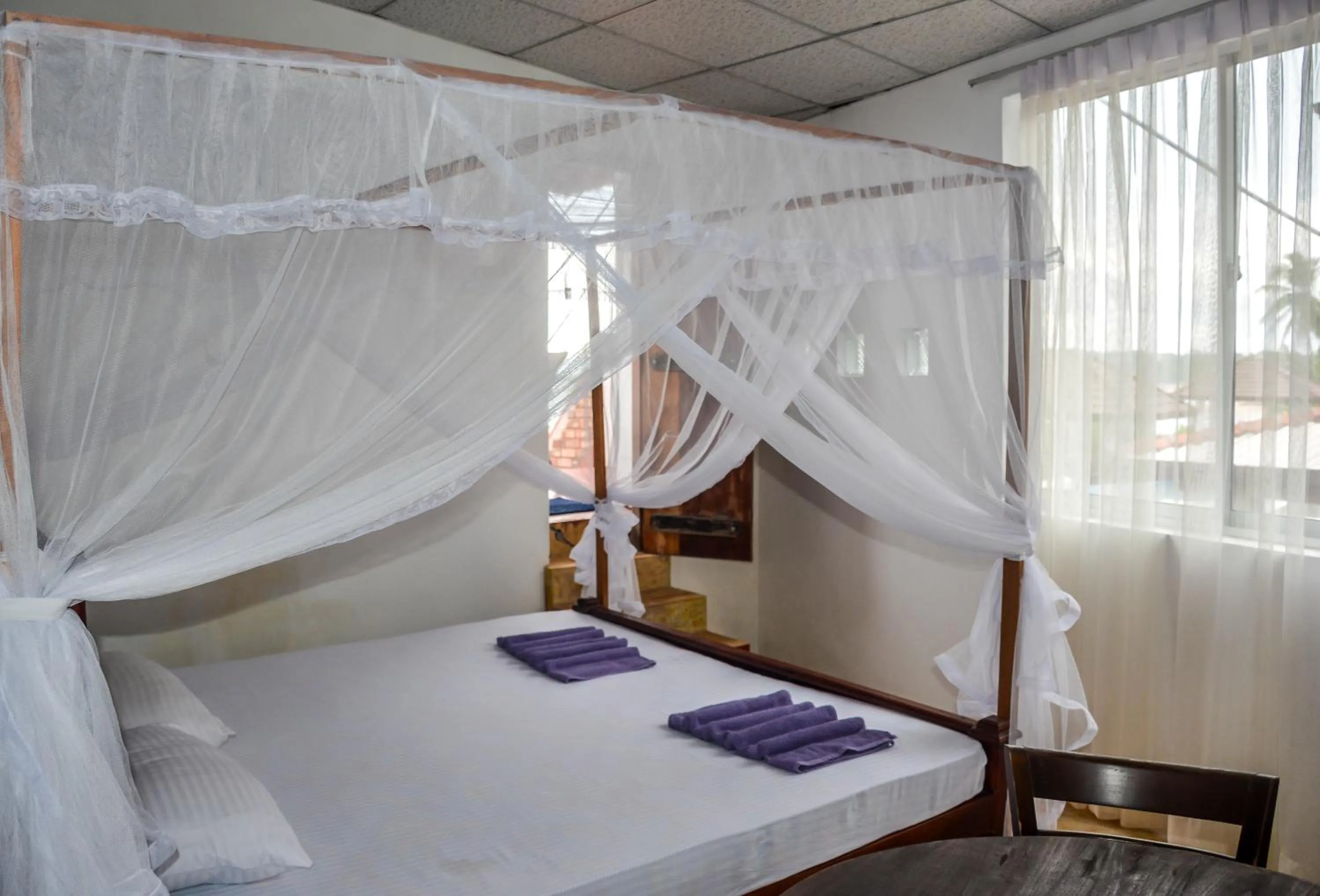 Bed in Blue Horizon Beach Hotel