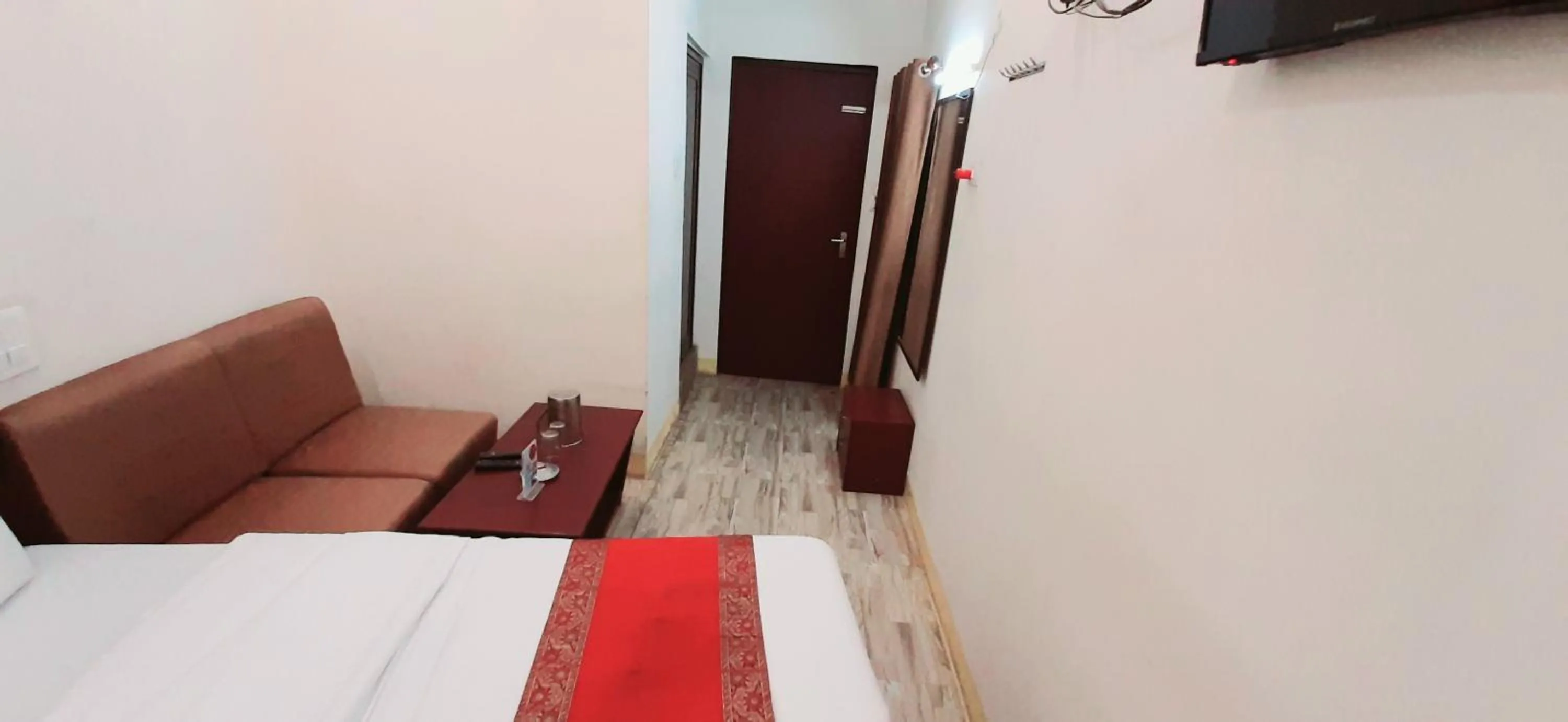 Seating area, Bed in Luxmi Hotel