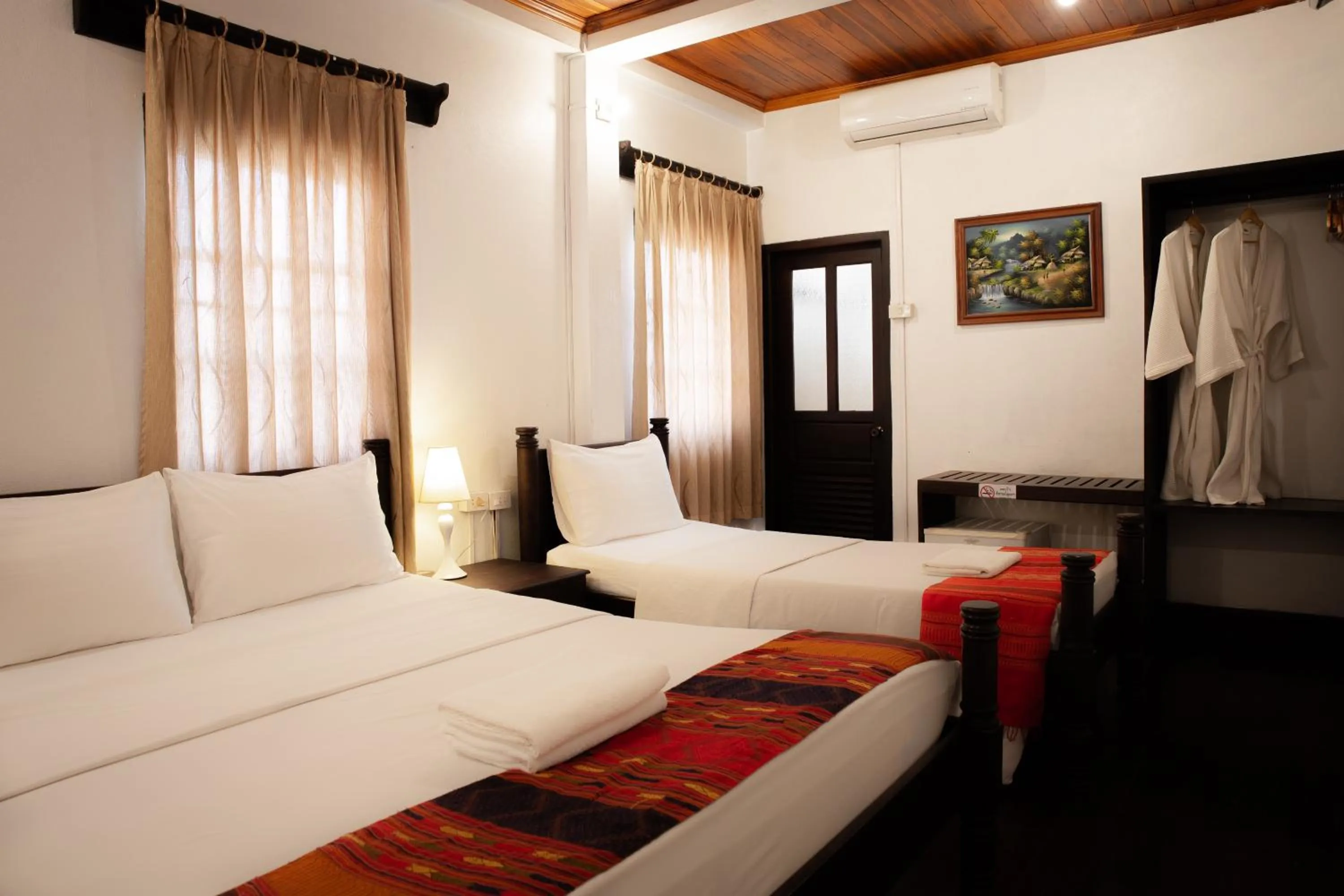 Bed in Villa Senesouk Luang Prabang