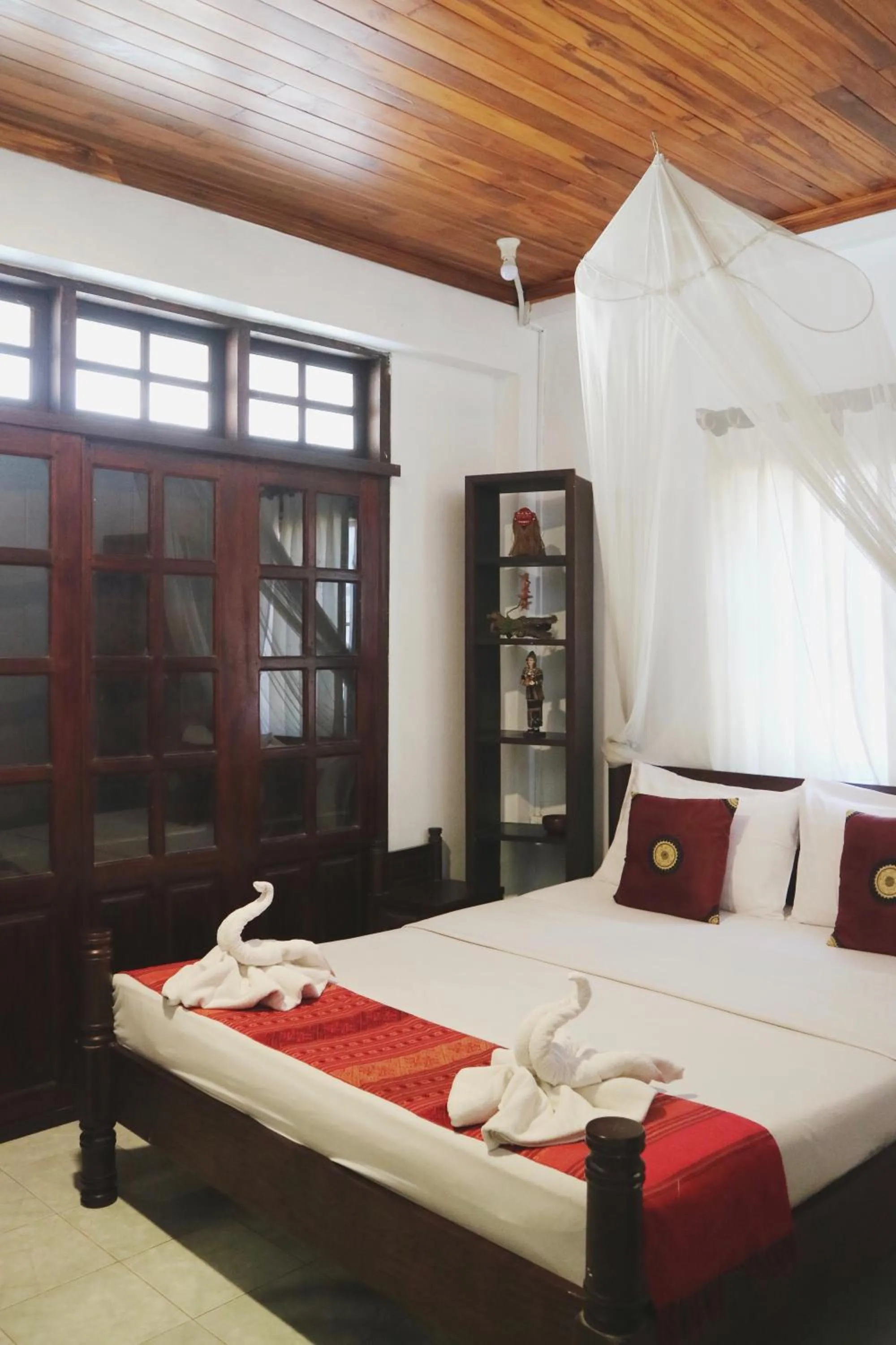 Bed in Villa Senesouk Luang Prabang