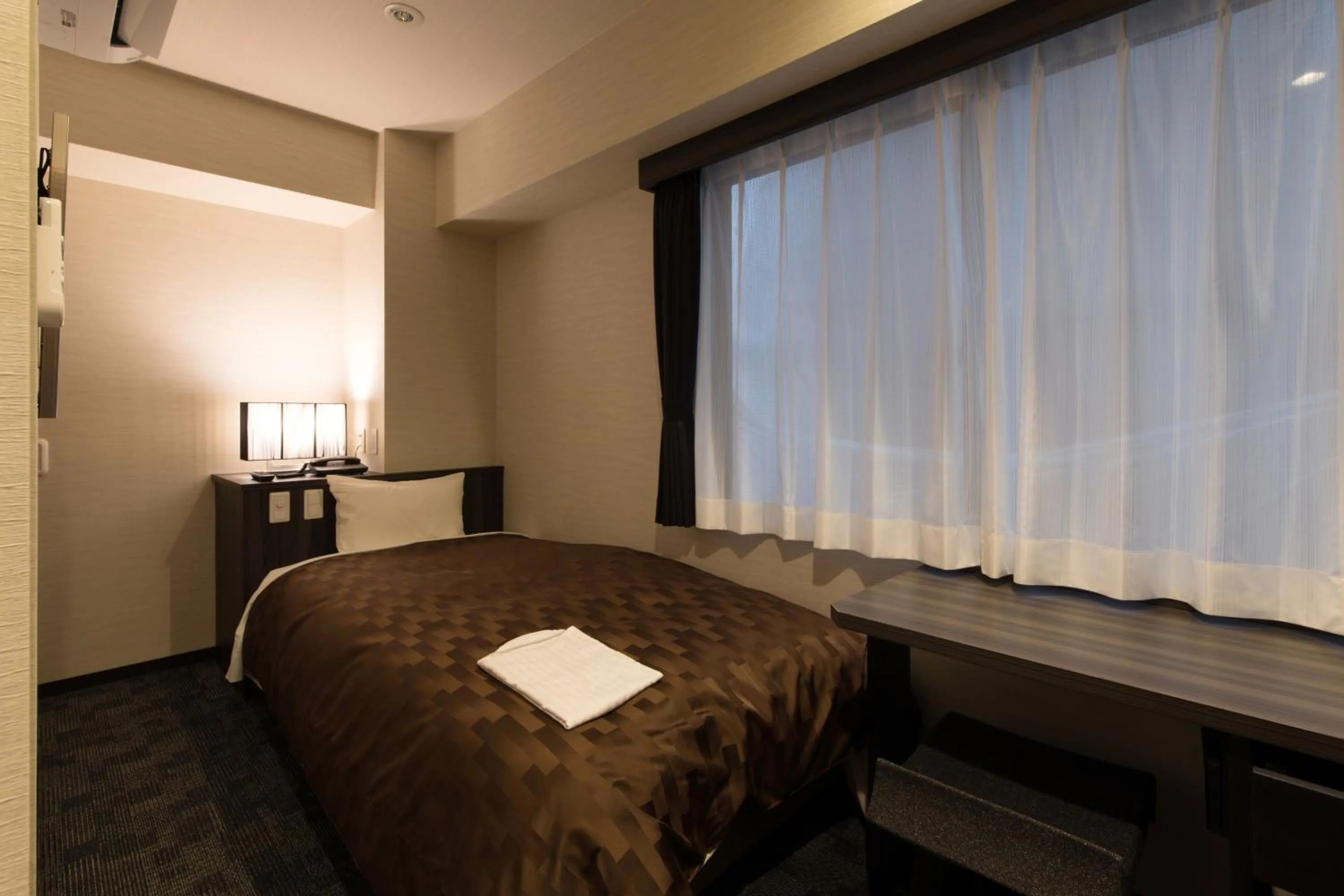 Bed in Hotel Taisei Nakanoshima