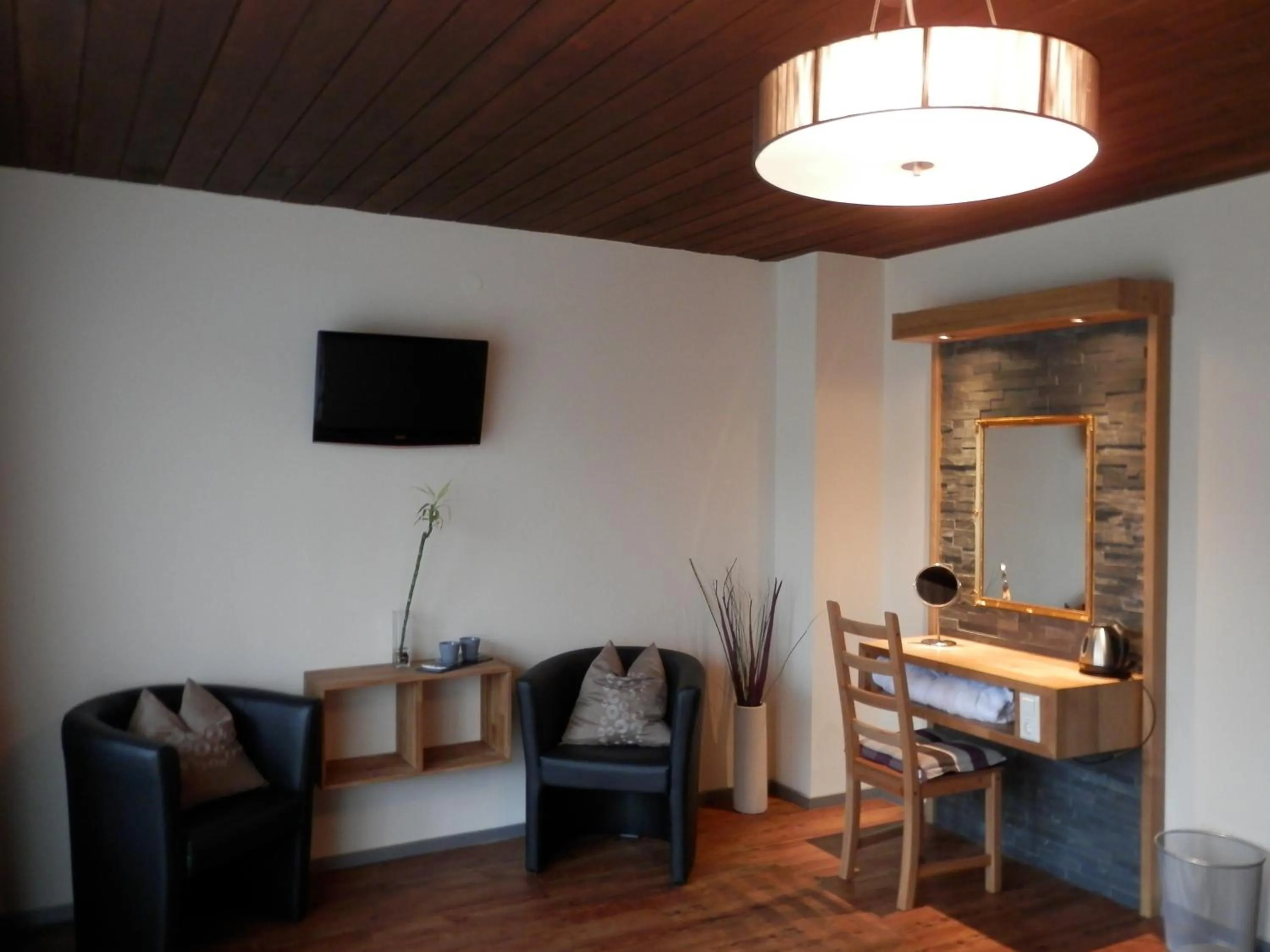 Seating area in Dahoam by Sarina - Rooms & Suites