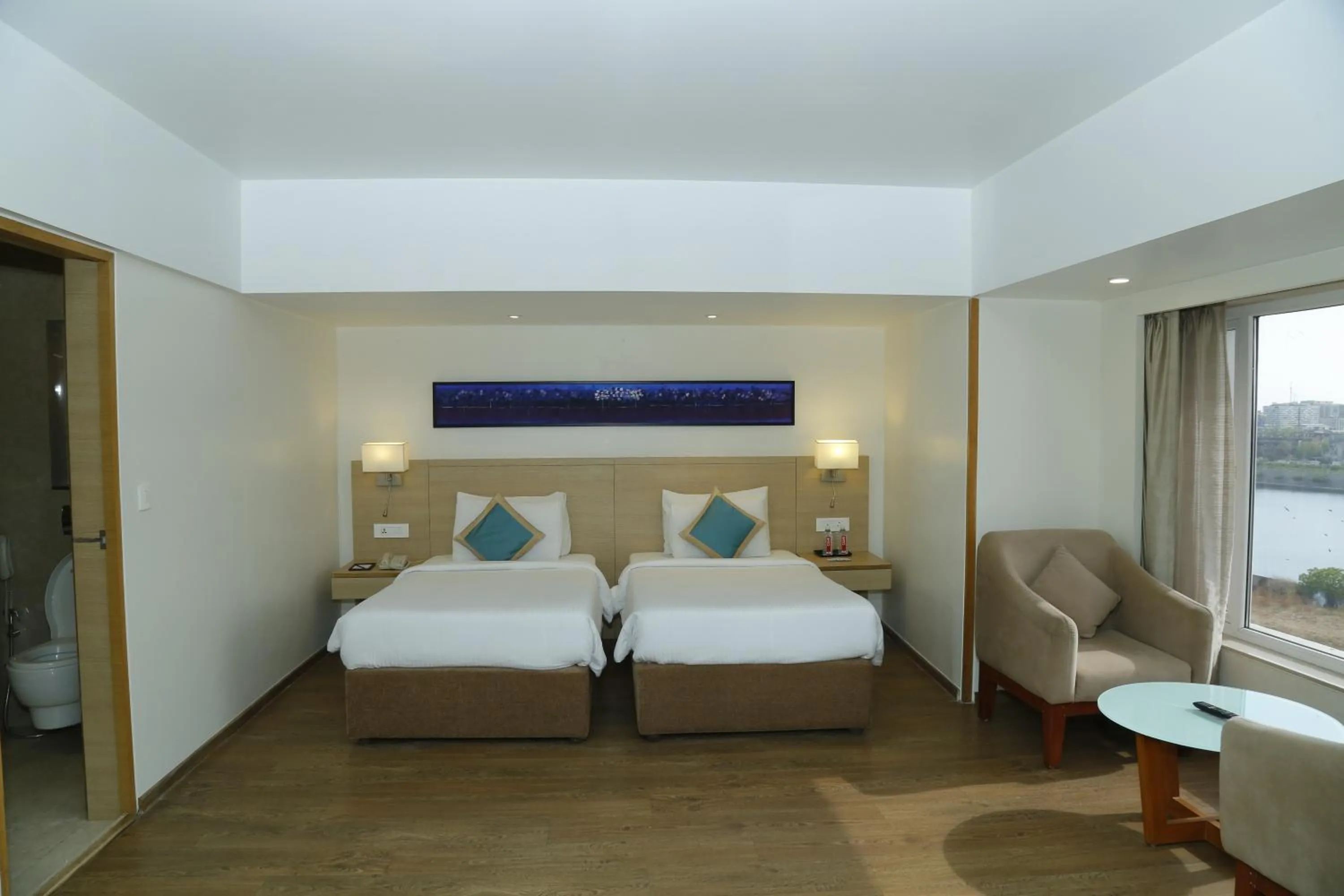 Bed in Sarovar Portico Rivera Ahmedabad