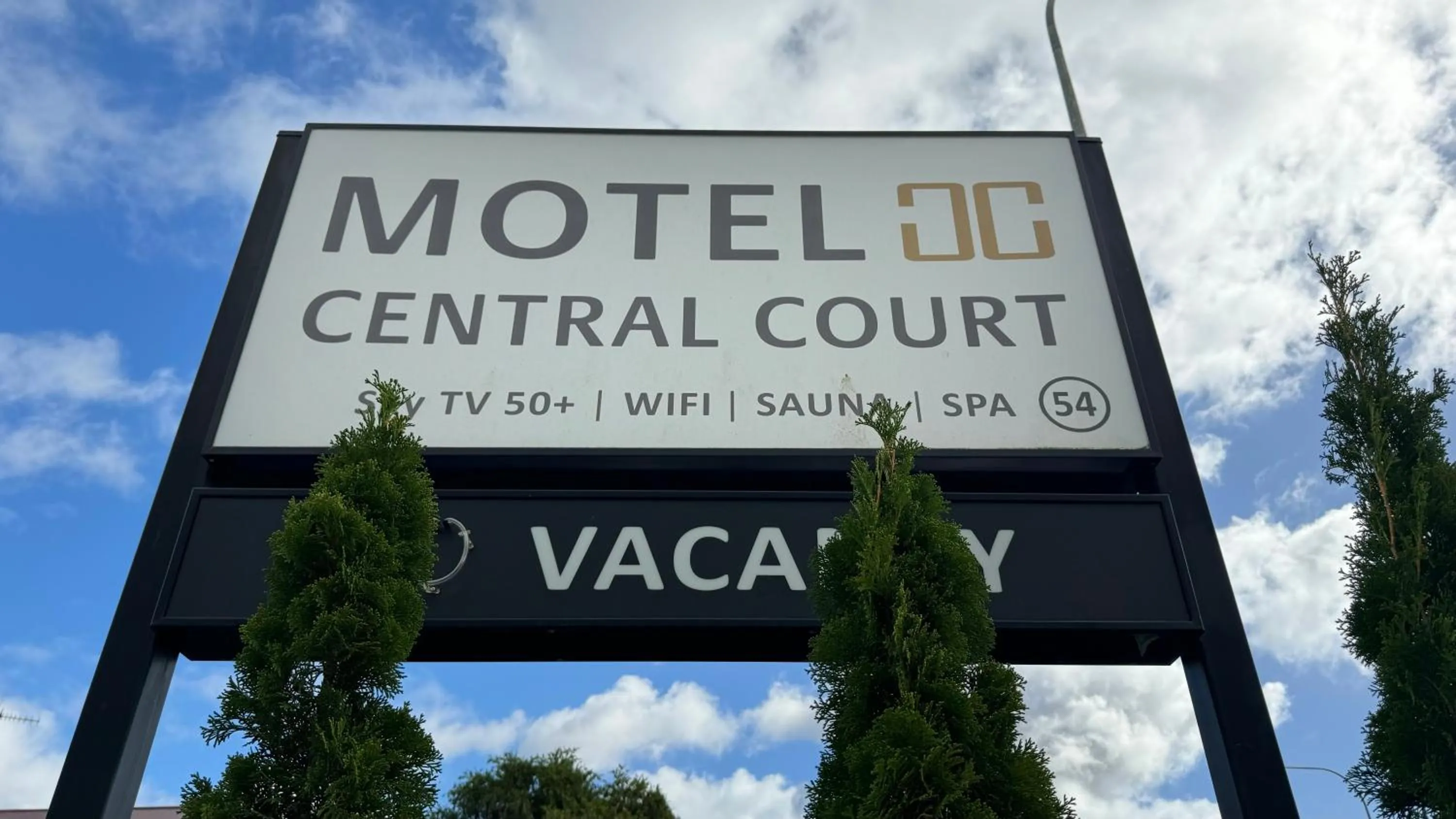 Property logo or sign in Central Court Motel