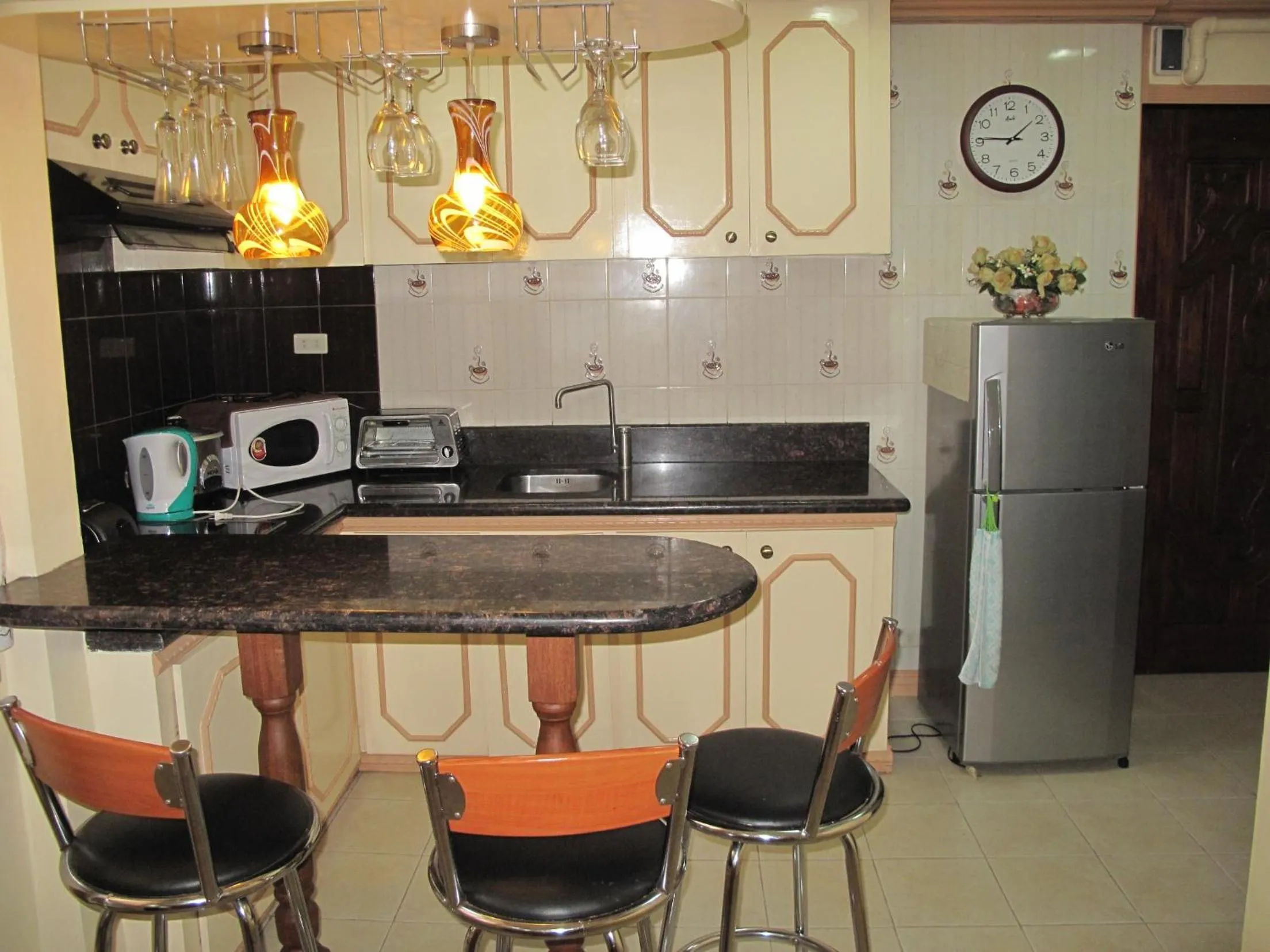 Kitchen or kitchenette in Makati Suites at Travelers Inn