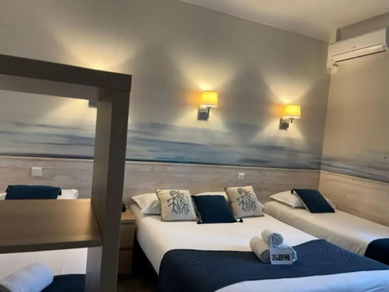 Standard Quadruple Room with window overlooking the parking in Hotel Pavillon Imperial Standard Quadruple Room with window overlooking the parking in Hotel Pavillon Imperial