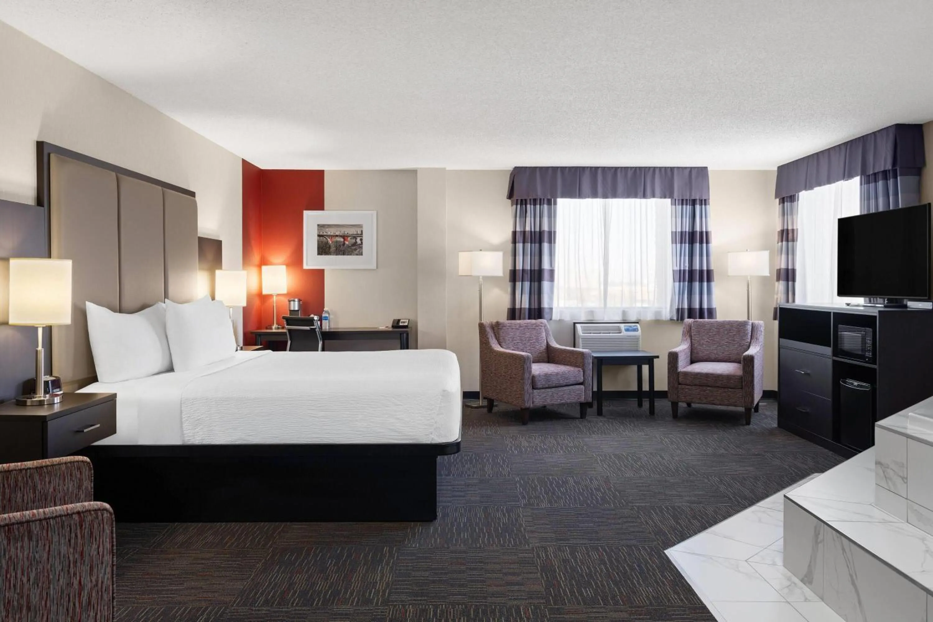 Photo of the whole room, Bed in Ramada by Wyndham Saskatoon