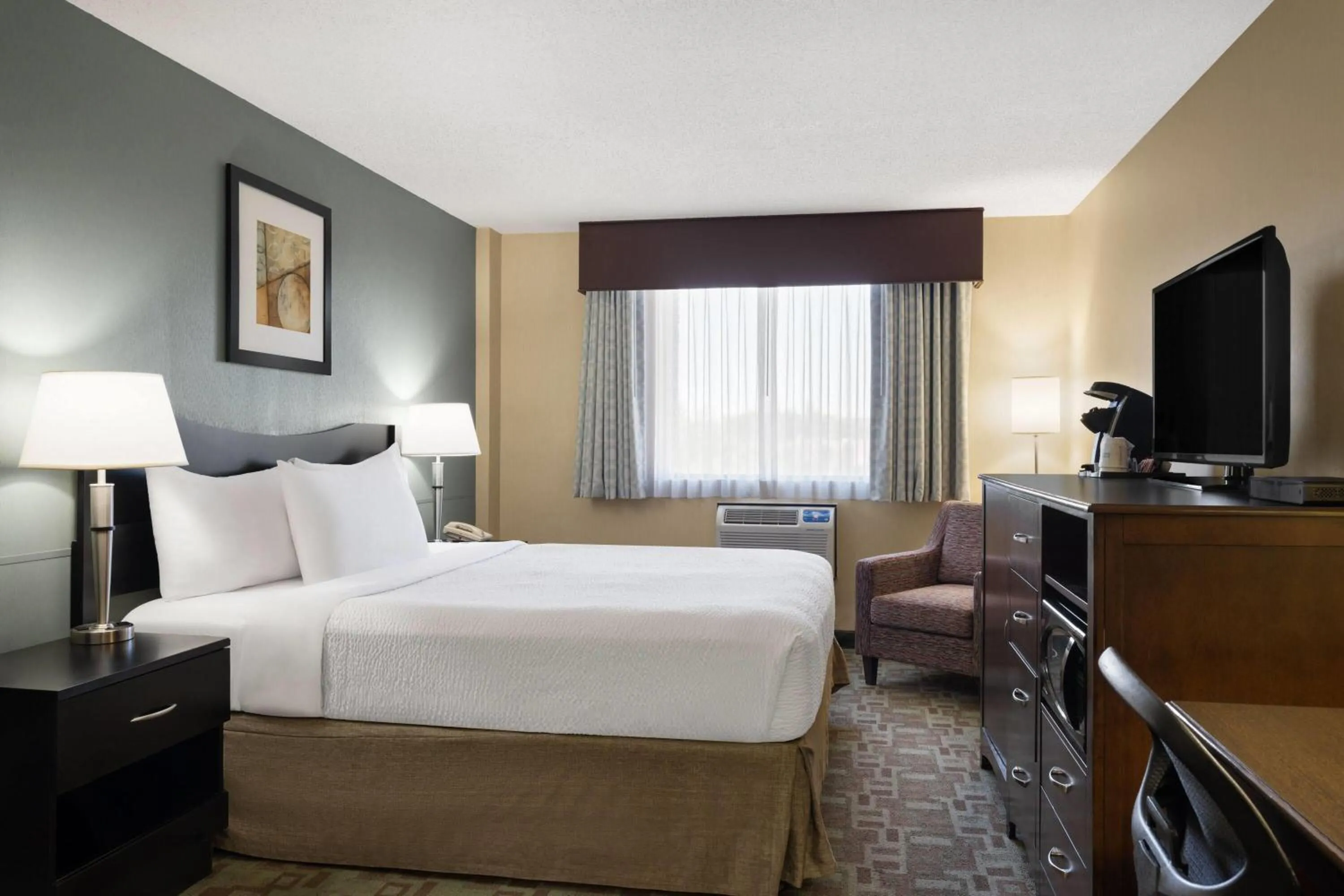 Photo of the whole room, Bed in Ramada by Wyndham Saskatoon
