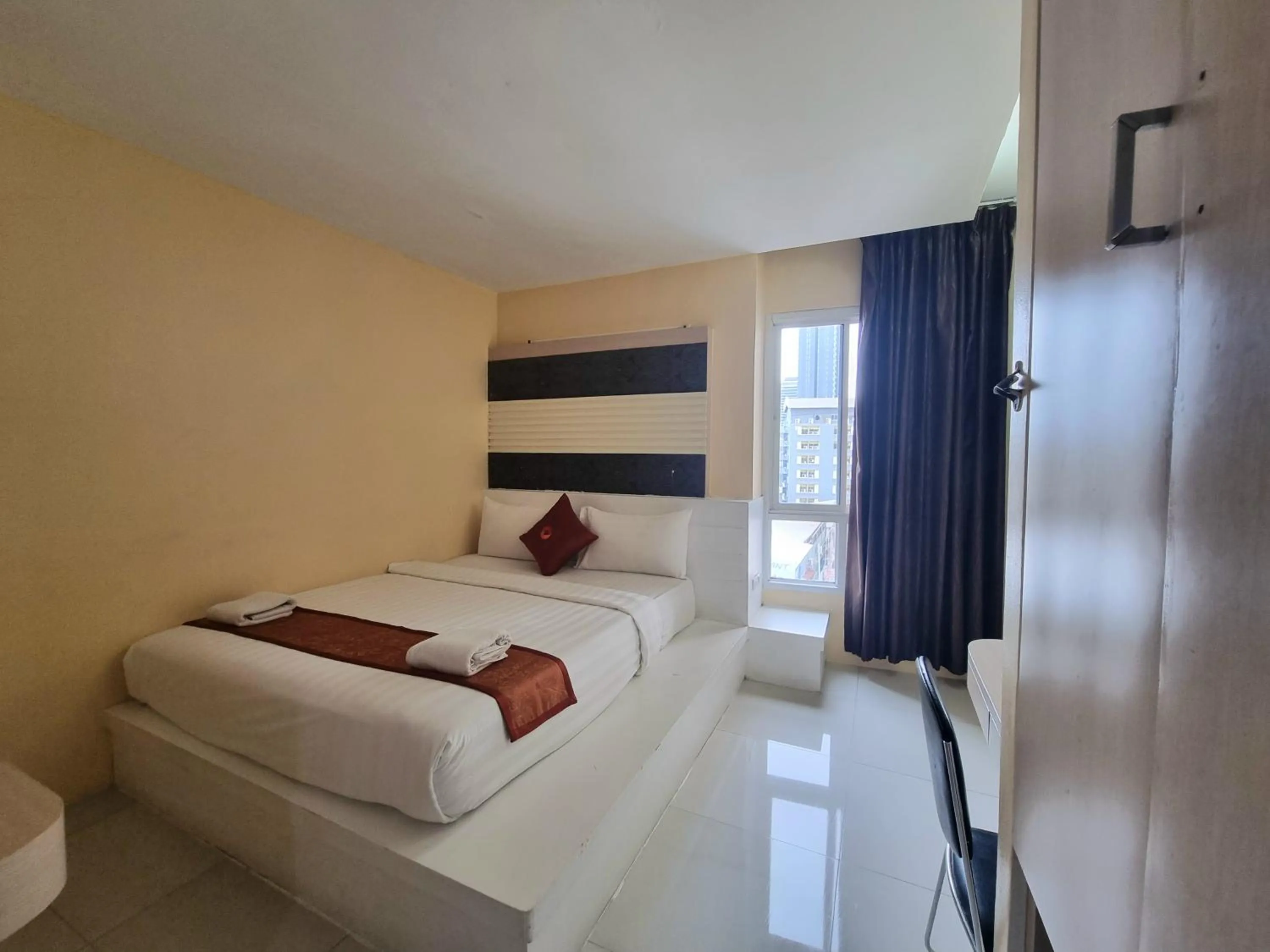 Bed in Cozi Inn Hotel, Bangkok