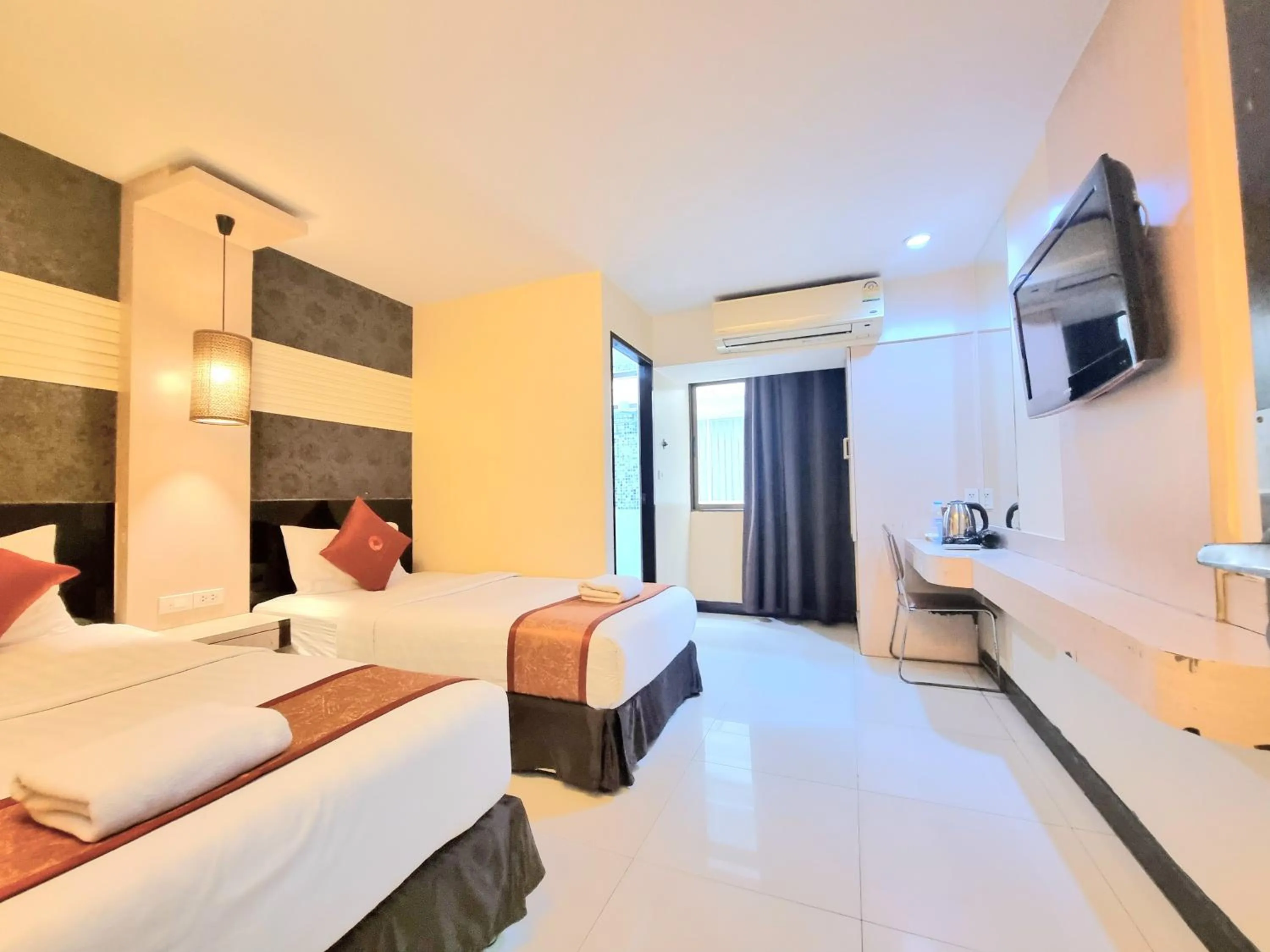 Bed in Cozi Inn Hotel, Bangkok