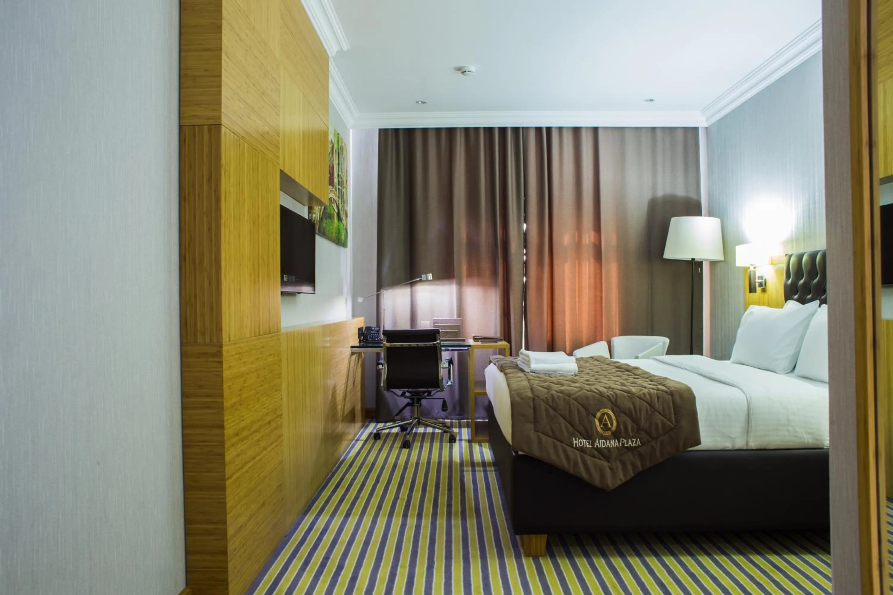 Bed in Aidana Plaza Hotel