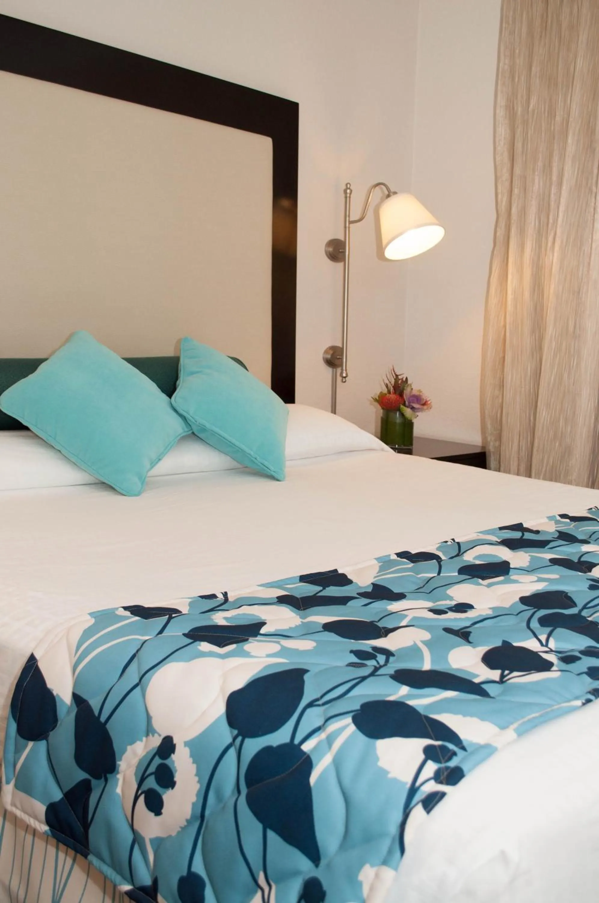 Bed in Laguna Shores Studio Suites