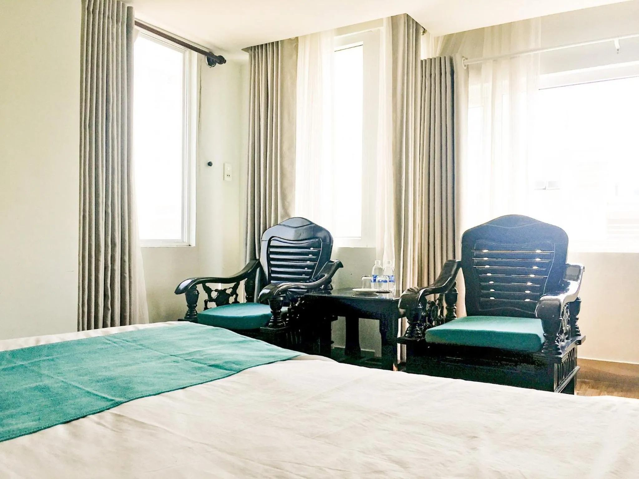 Seating area, Bed in The Sunriver Boutique Hotel Hue