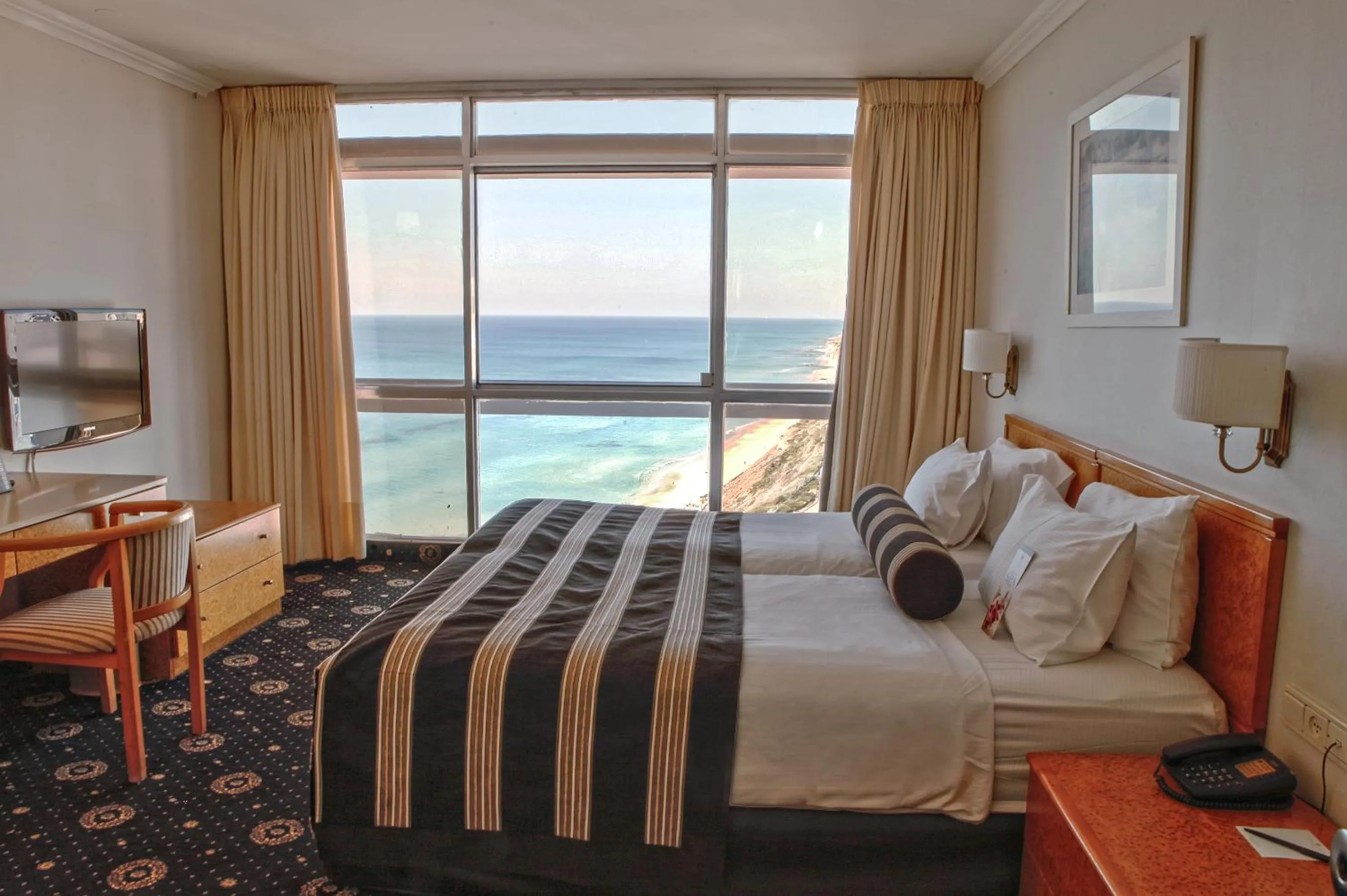 Bed in The Seasons Hotel -Studio & Suite