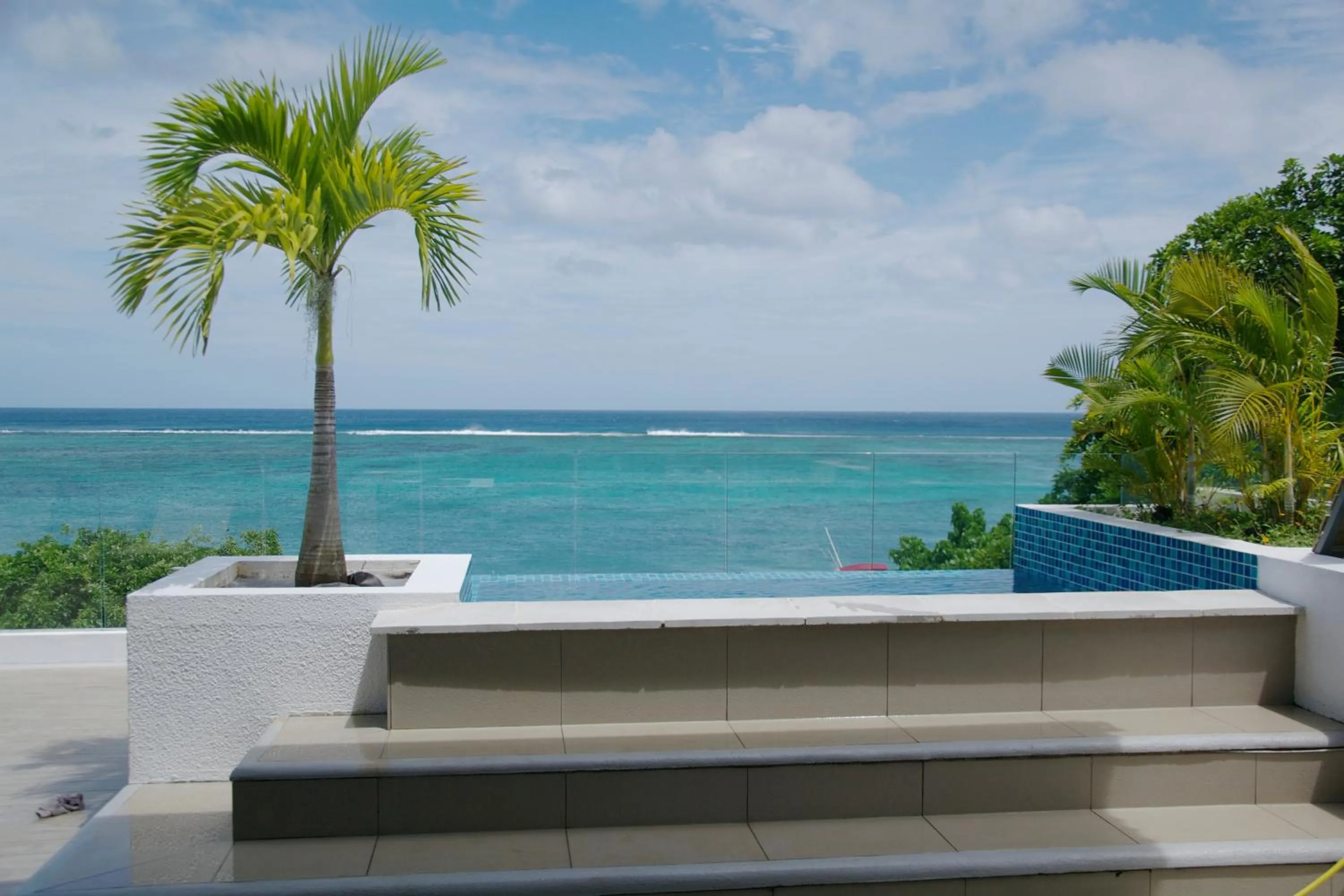 Swimming pool in Cap Ouest Beachfront Luxury Penthouse & Apartment