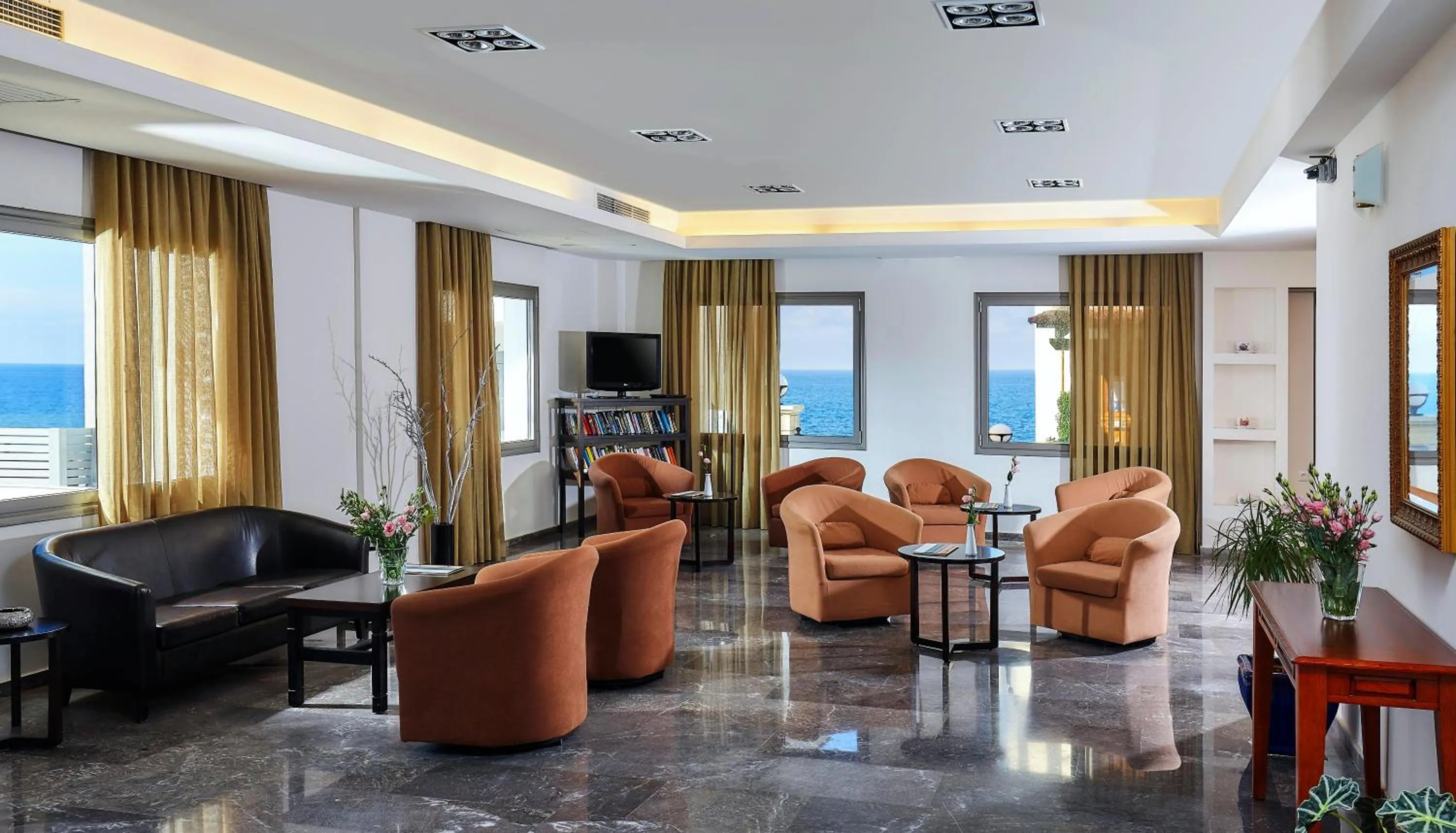 Communal lounge/ TV room in Panormo Beach Hotel