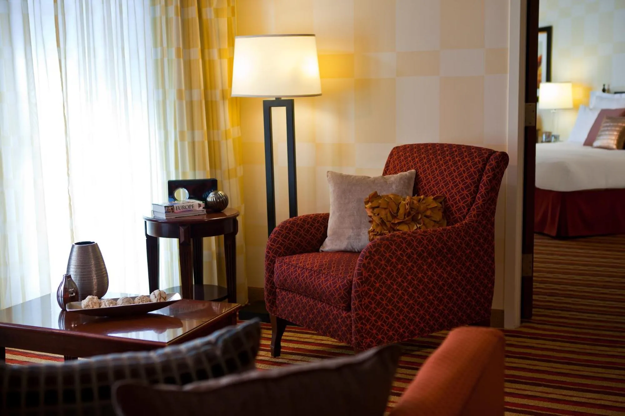 Seating area, Bed in Wyndham Grand Oklahoma City Downtown
