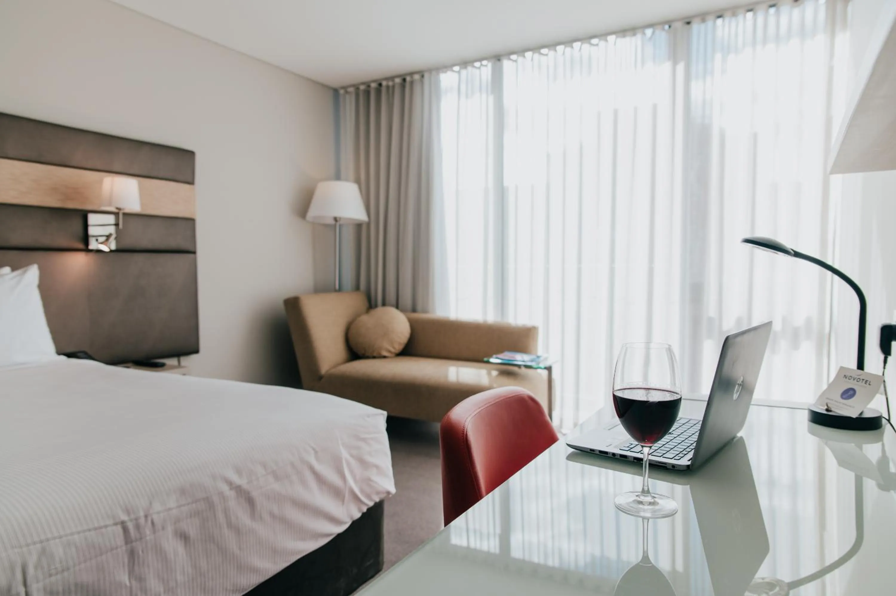 Seating area, Bed in Novotel Newcastle Beach