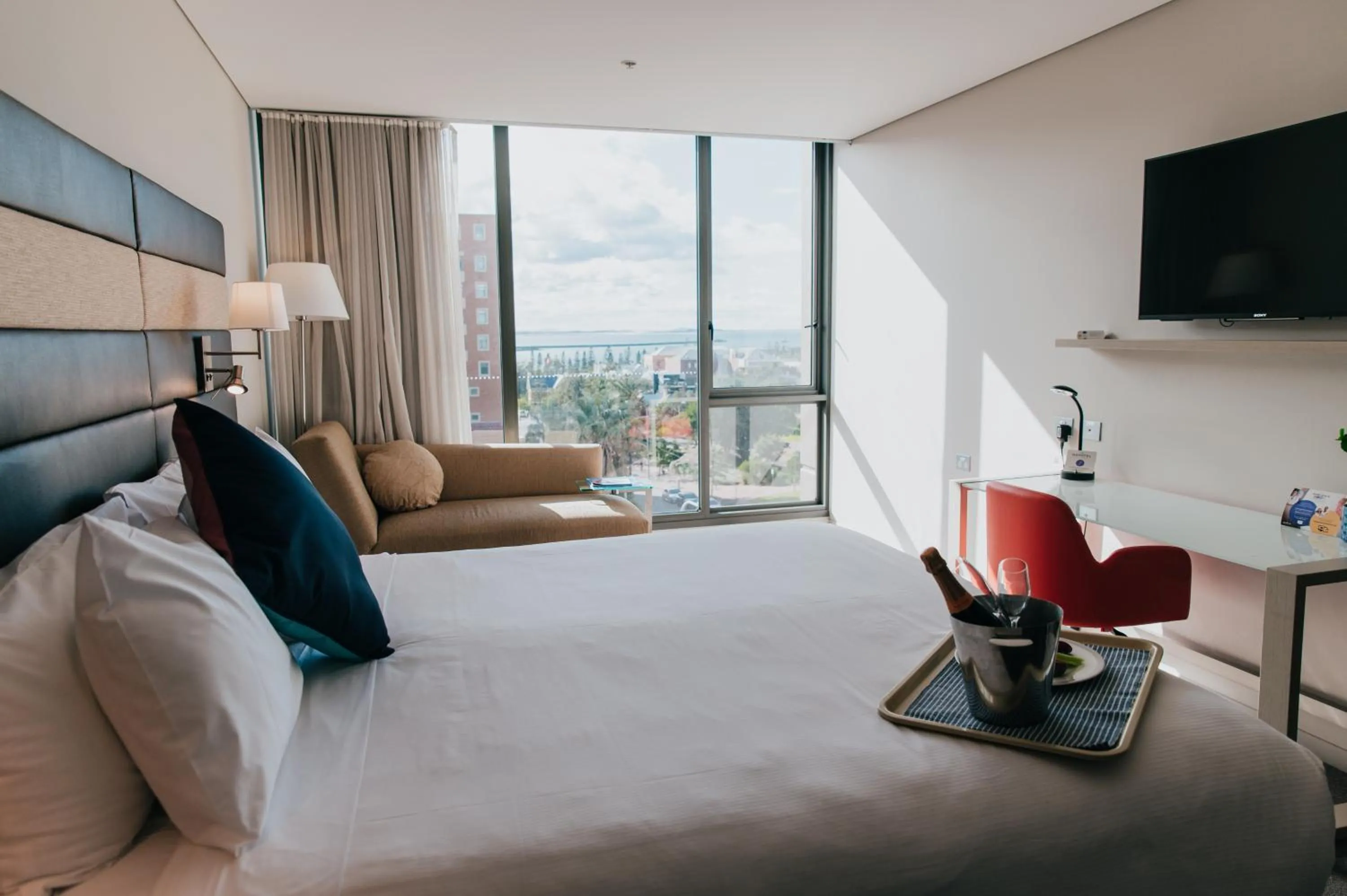 Seating area, Bed in Novotel Newcastle Beach