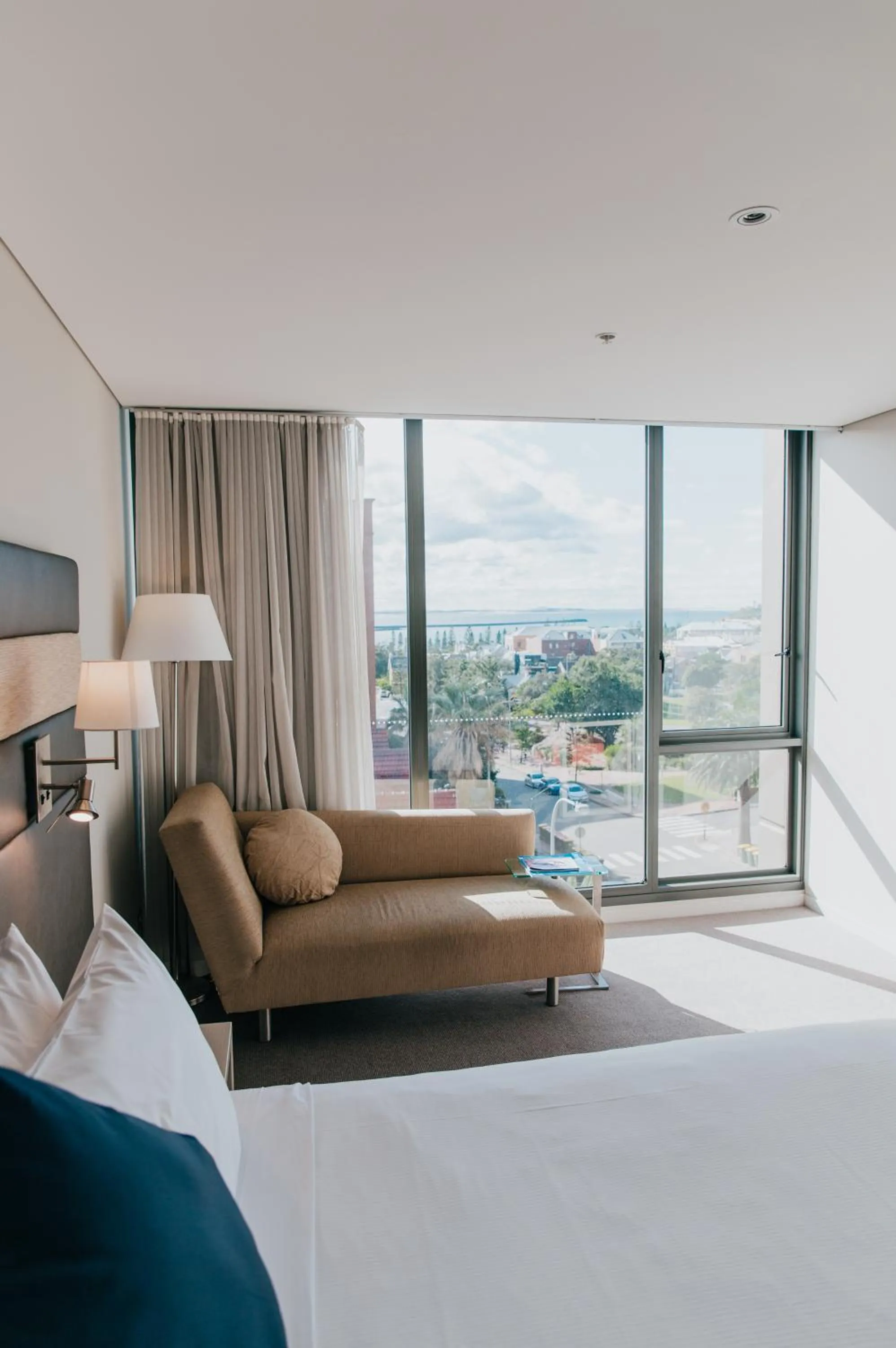 Seating area, Bed in Novotel Newcastle Beach