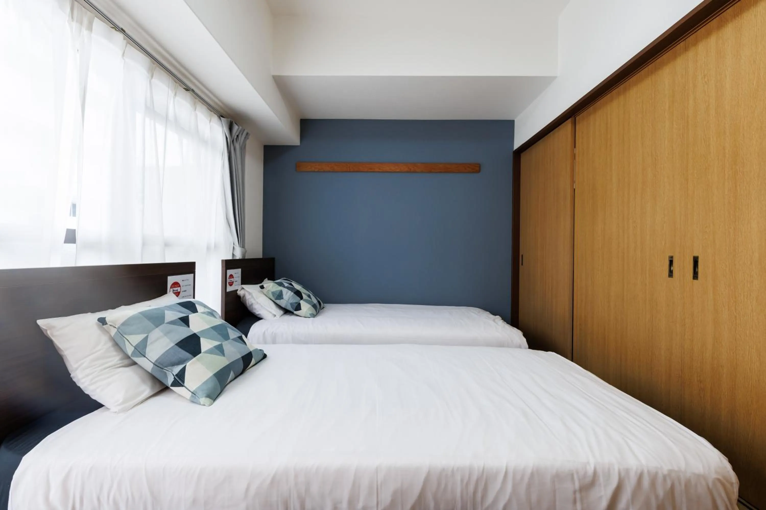 Bed in Grande Famille Shimanouchi Dotonbori Condo