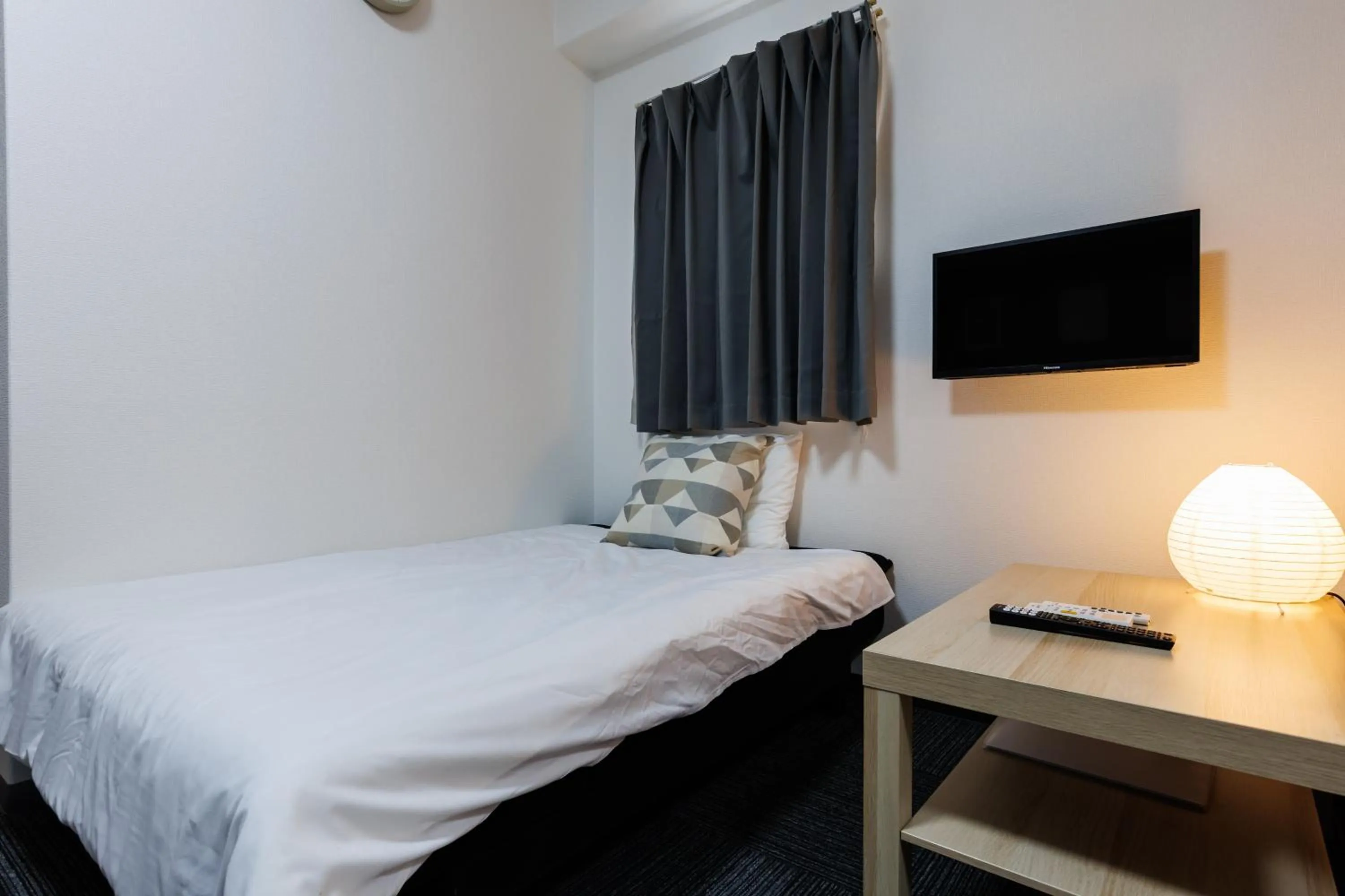 Bed in Grande Famille Shimanouchi Dotonbori Condo