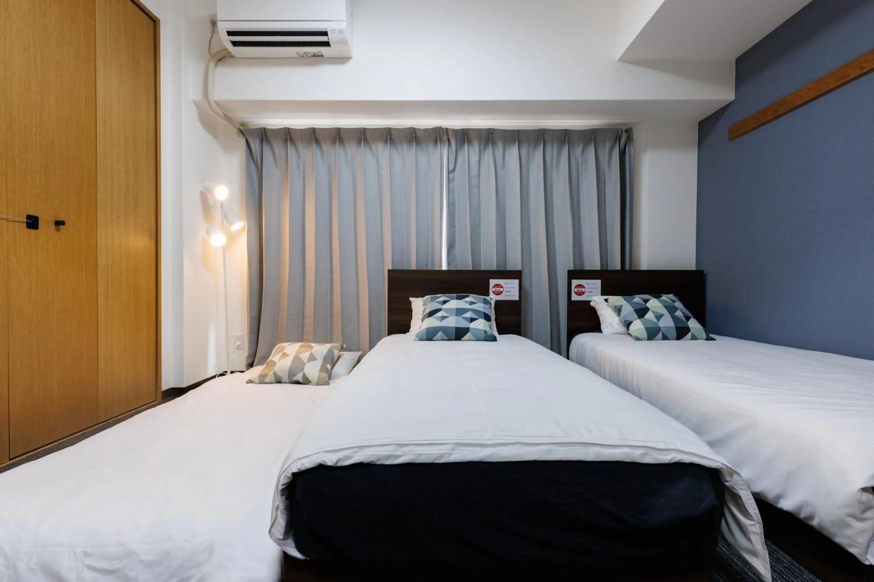 Bed in Grande Famille Shimanouchi Dotonbori Condo