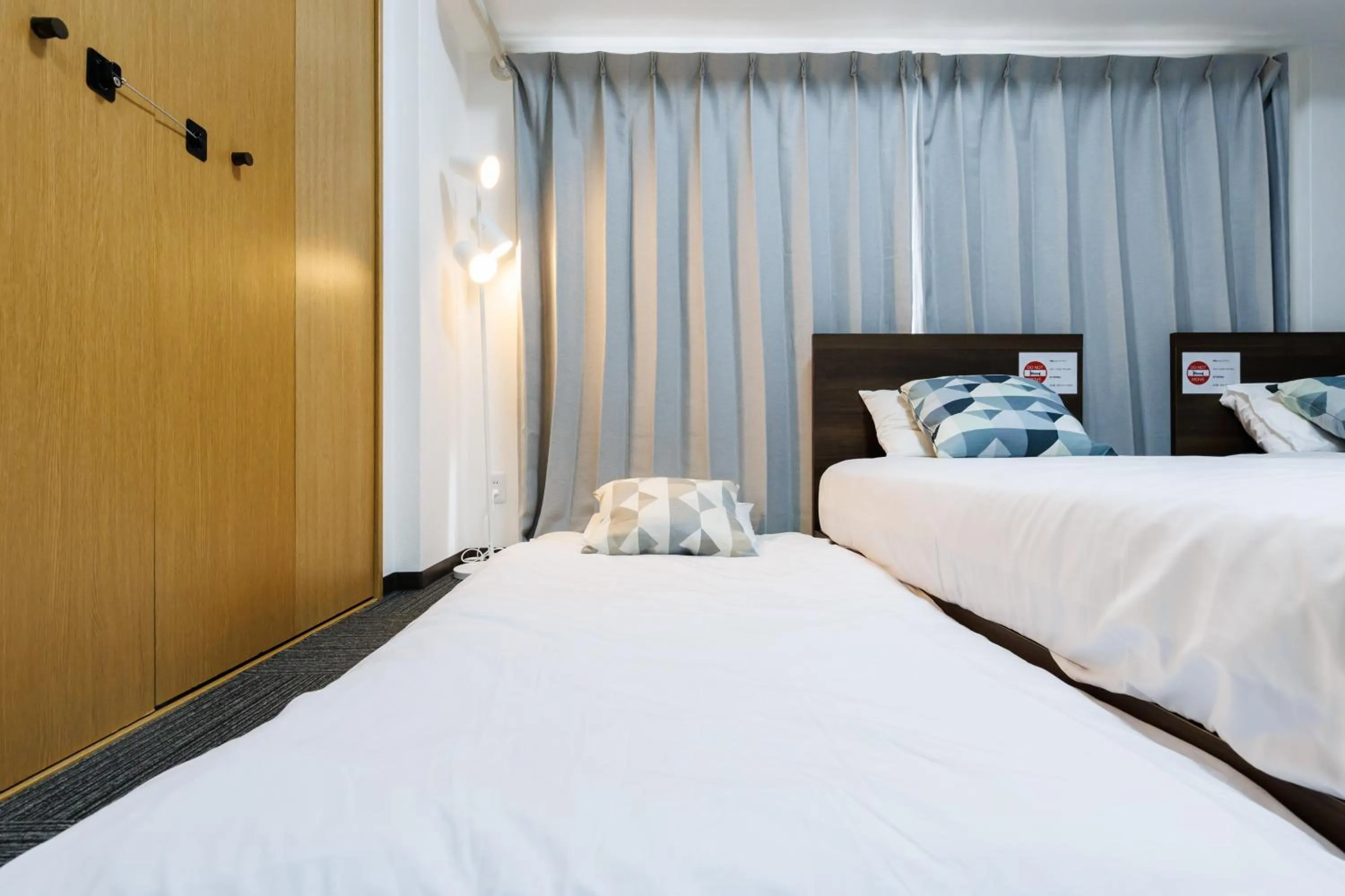 Bed in Grande Famille Shimanouchi Dotonbori Condo