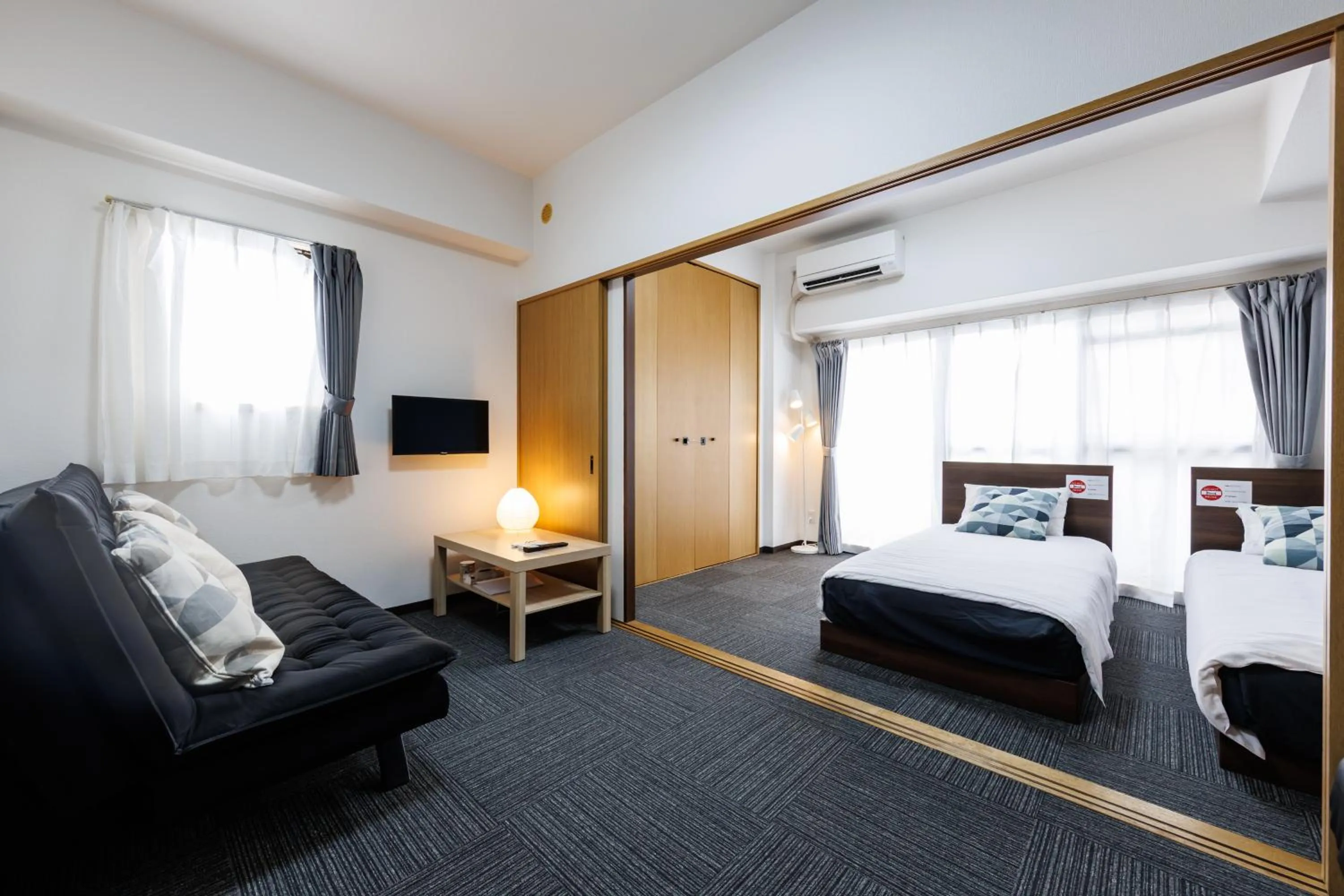Bed in Grande Famille Shimanouchi Dotonbori Condo