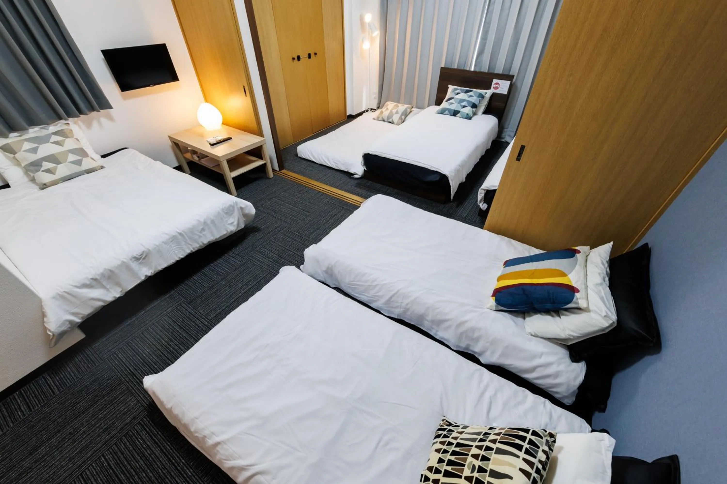 Bed in Grande Famille Shimanouchi Dotonbori Condo