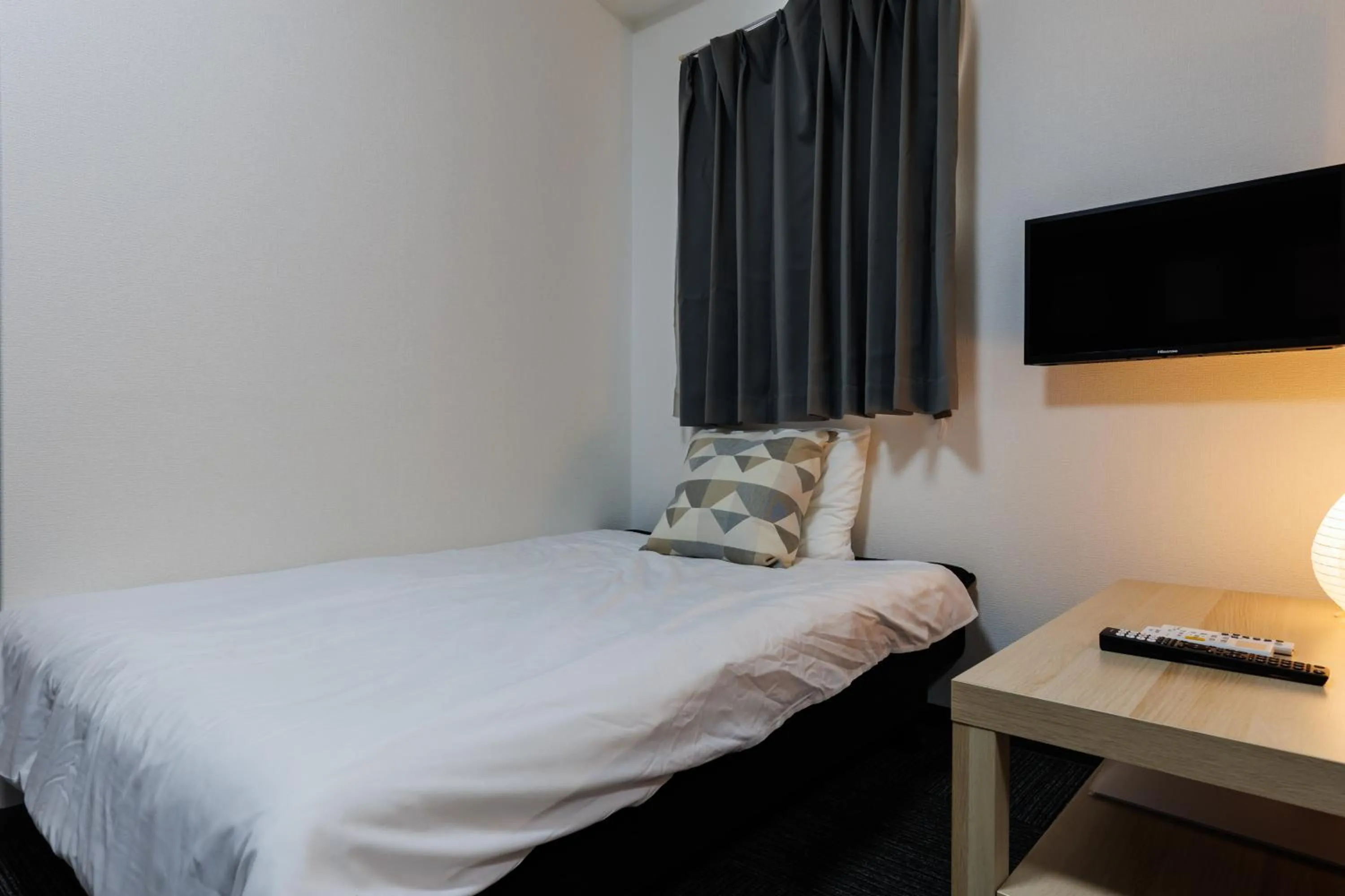 Bed in Grande Famille Shimanouchi Dotonbori Condo