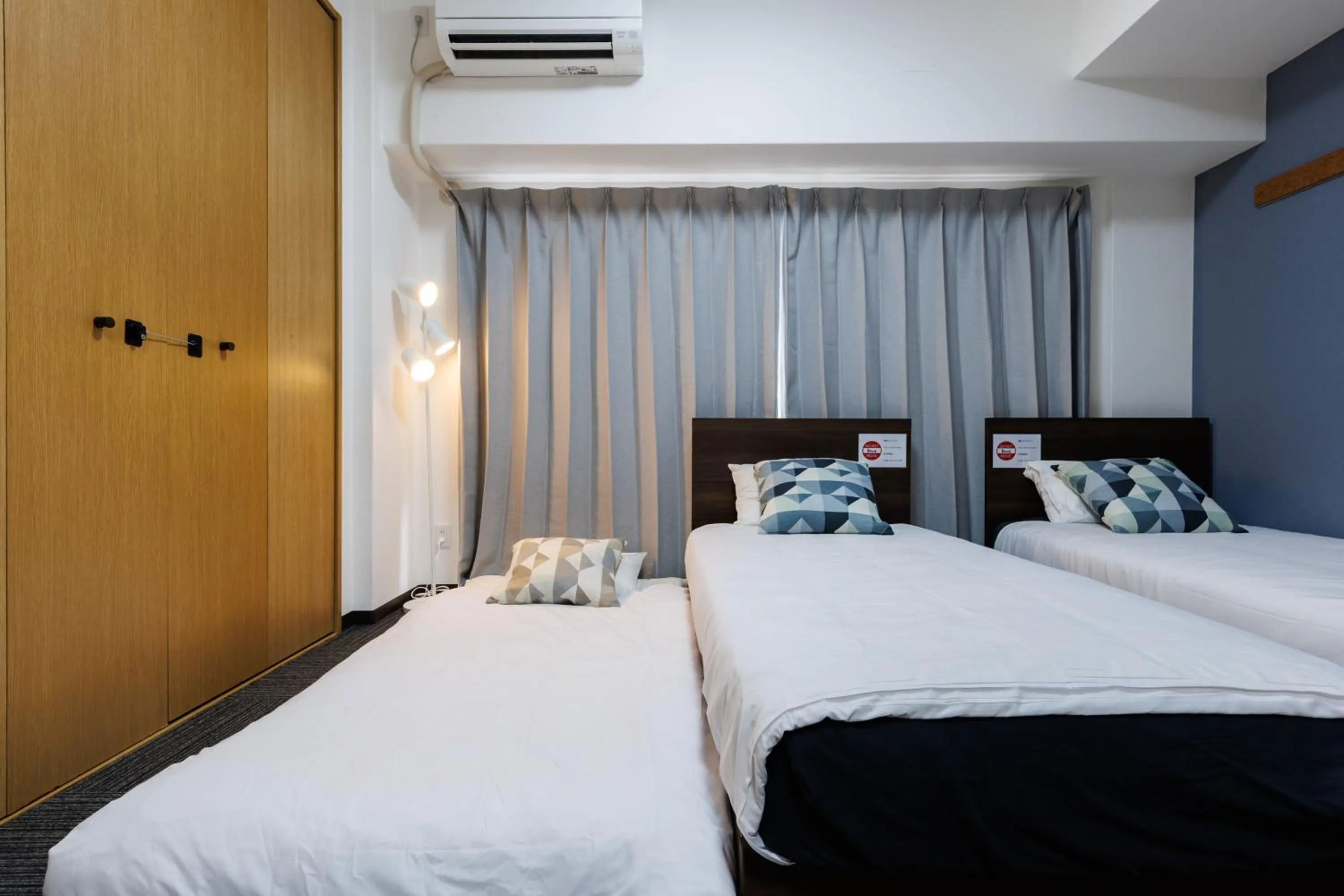 Bed in Grande Famille Shimanouchi Dotonbori Condo