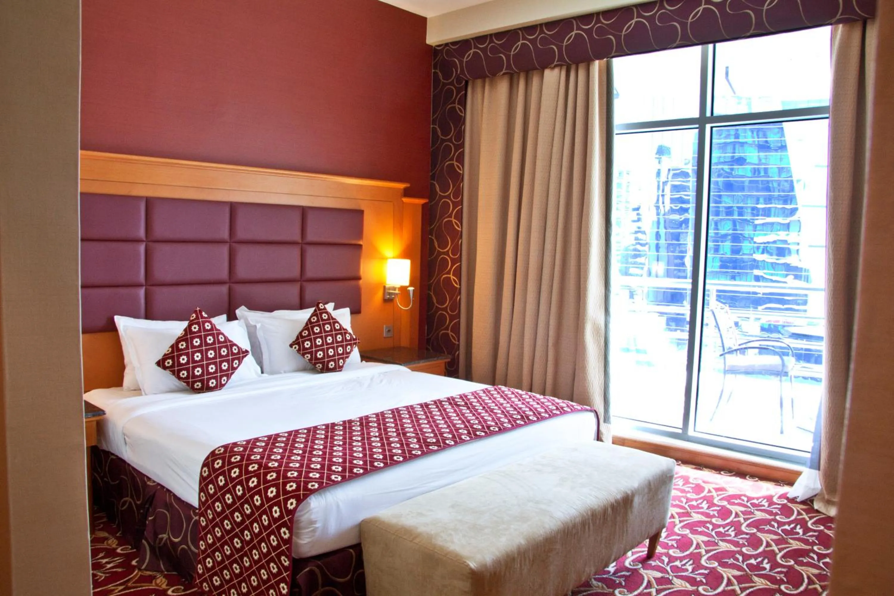 Bed in Ramee Rose Hotel