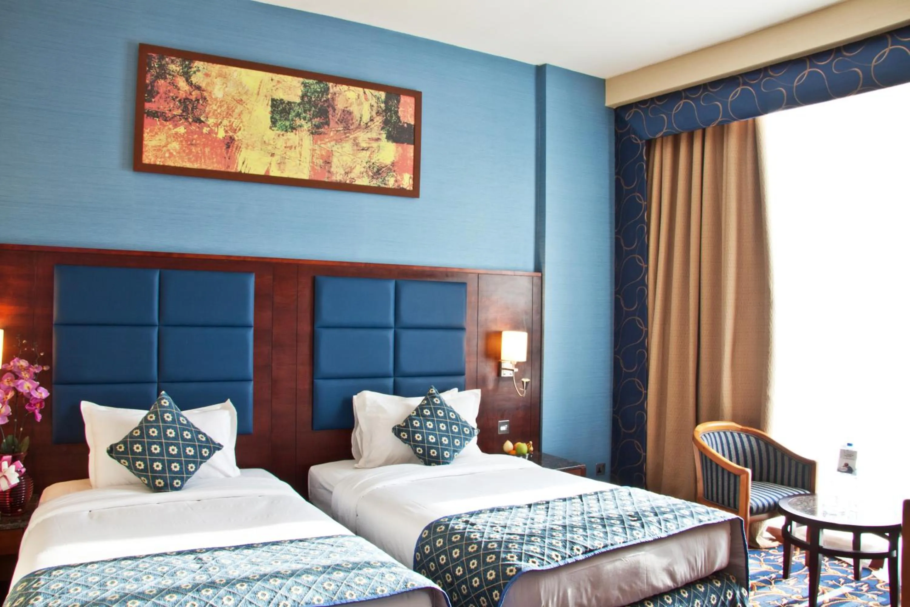 Bed in Ramee Rose Hotel