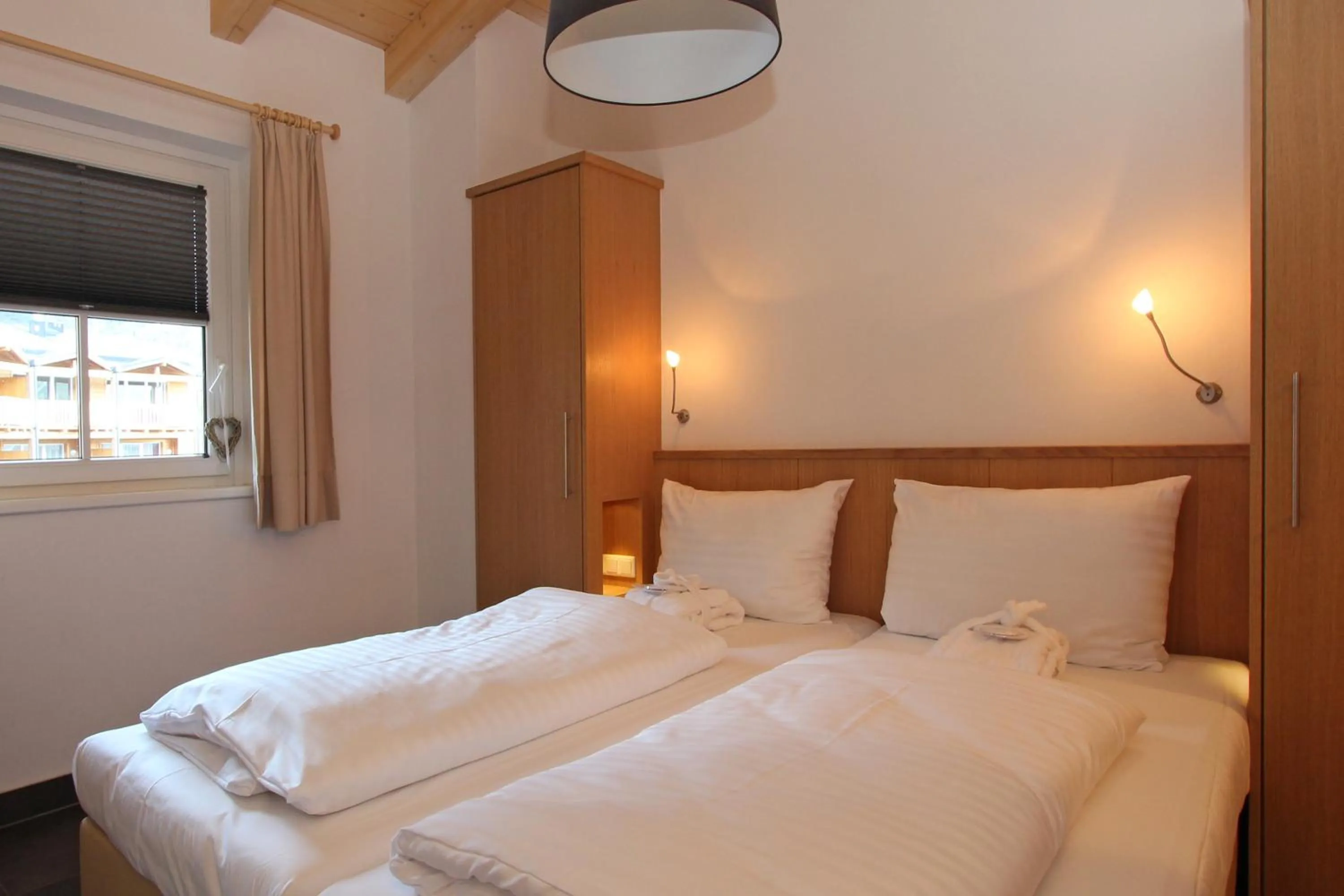 Bed in AvenidA Mountain Resort by Alpin Rentals