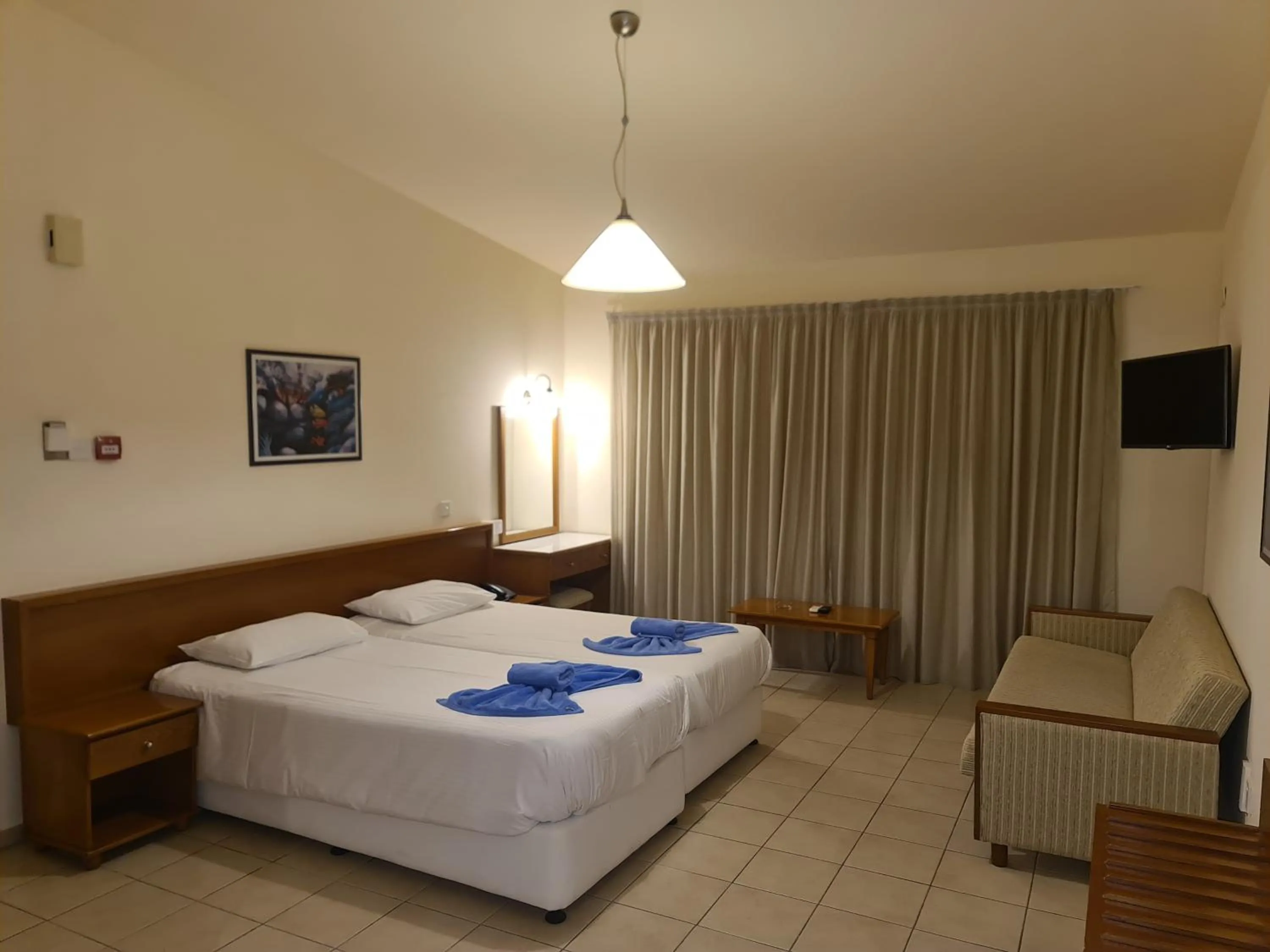 Bed in Nissiana Hotel & Bungalows