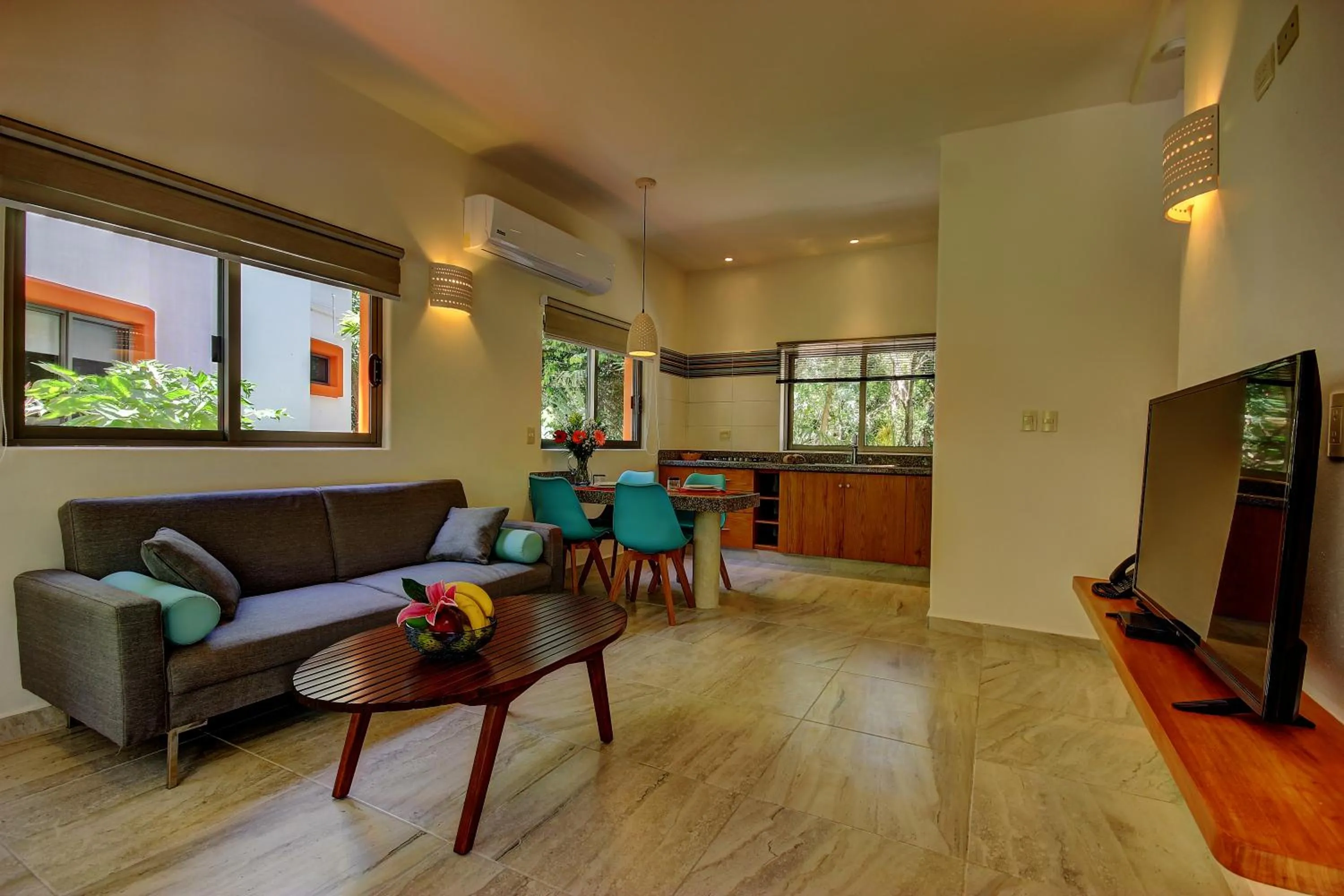 Communal lounge/ TV room in Riviera Maya Suites