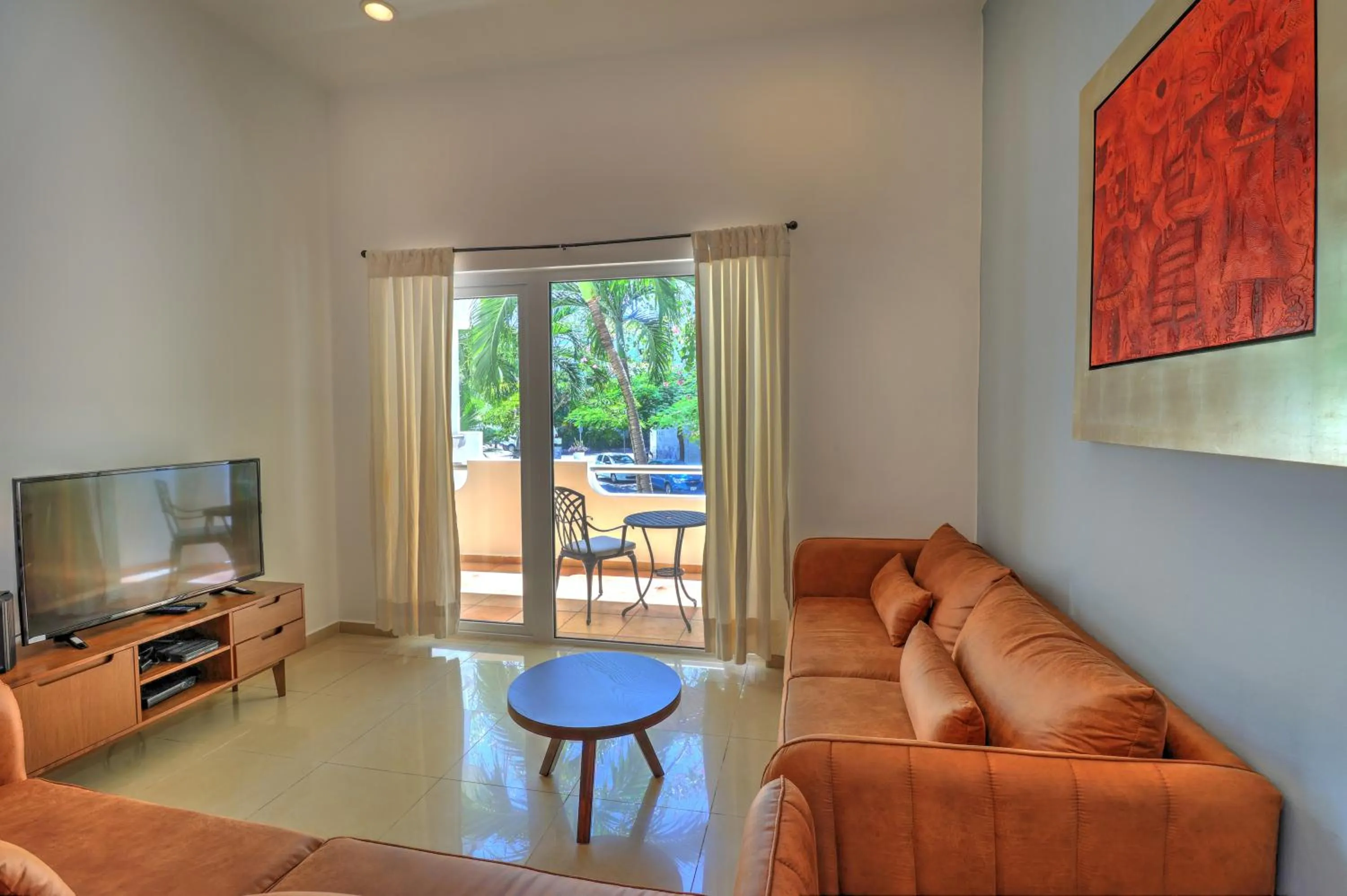 Communal lounge/ TV room in Riviera Maya Suites