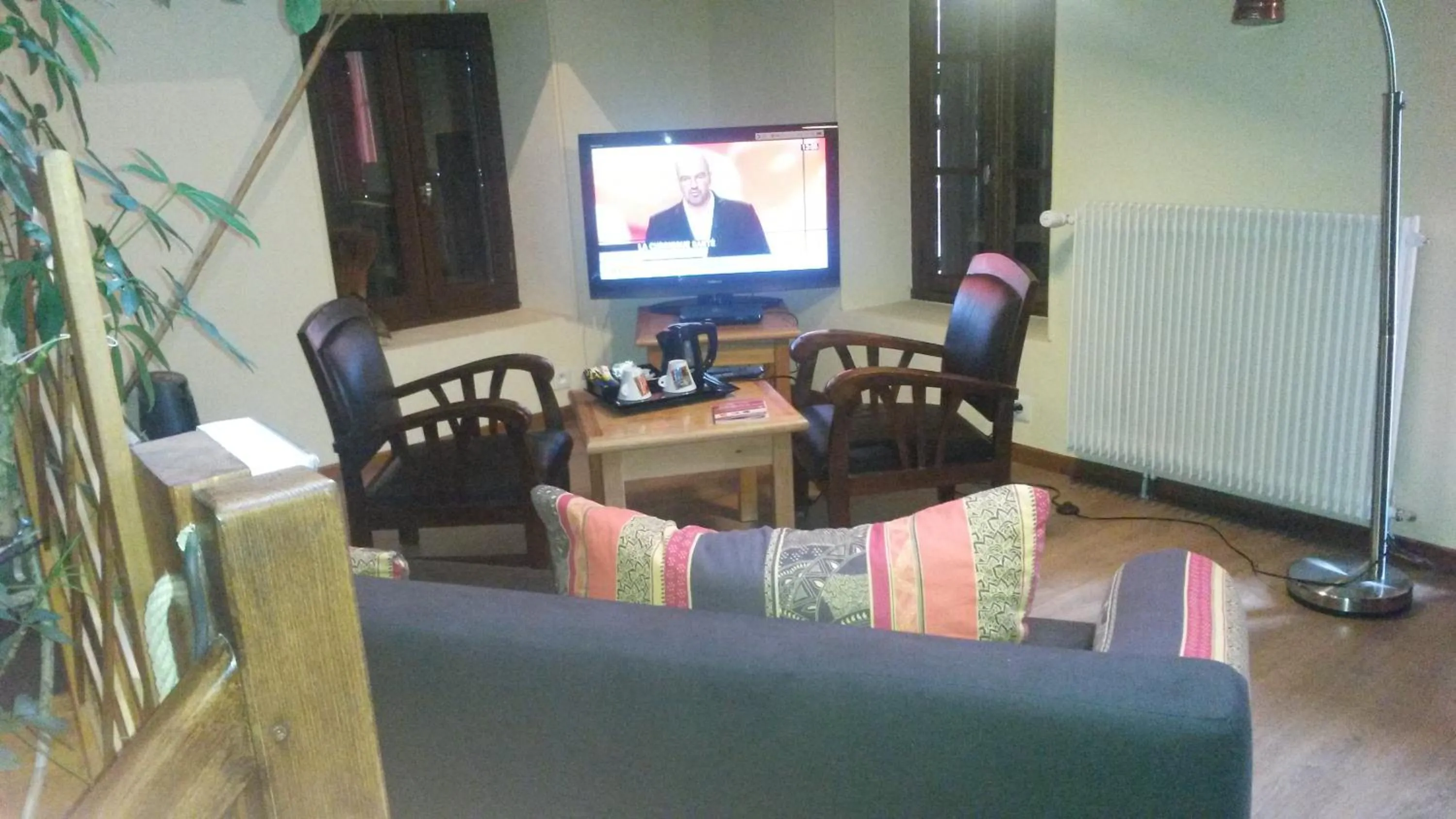 Communal lounge/ TV room in Auberge de la Petite Ferme, Super-Besse Est, The Originals Relais