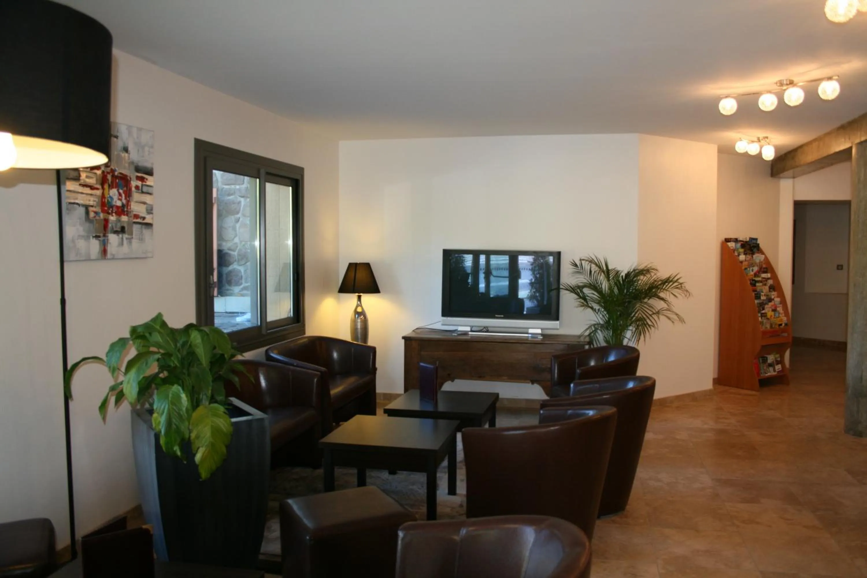 Communal lounge/ TV room in Auberge de la Petite Ferme, Super-Besse Est, The Originals Relais