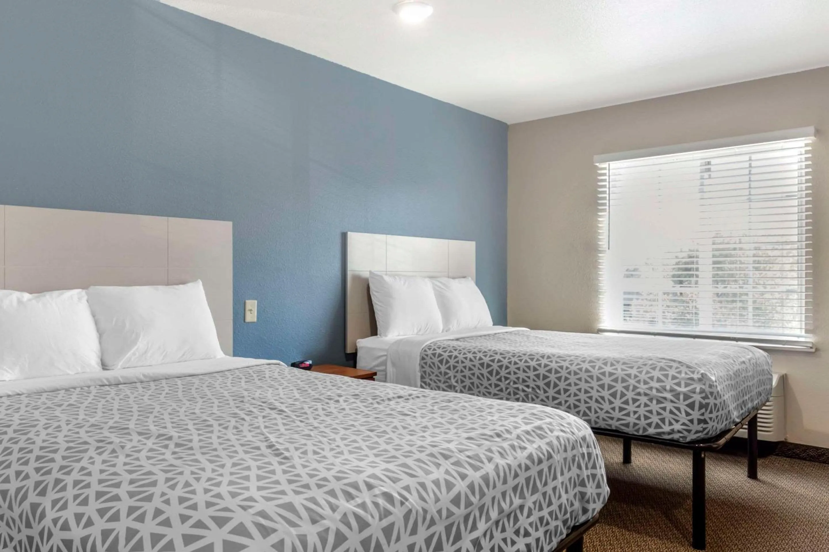 Bedroom, Bed in WoodSpring Suites Raleigh Garner