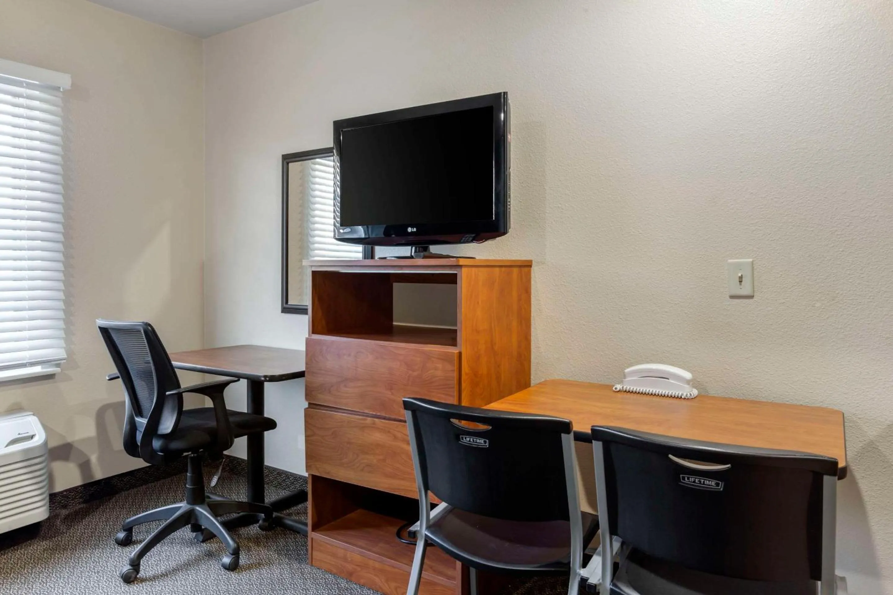 Bedroom in WoodSpring Suites Raleigh Garner