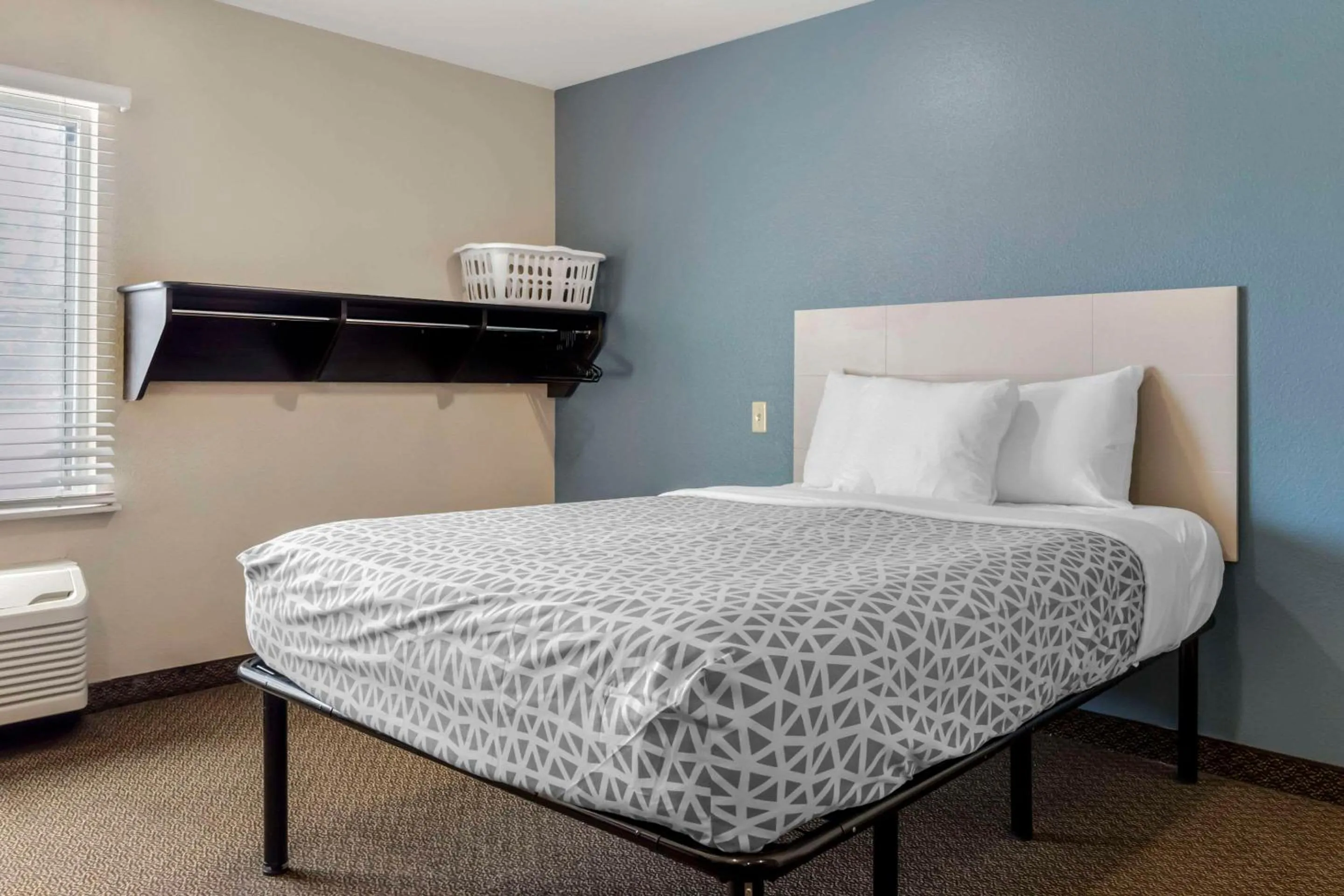 Bedroom, Bed in WoodSpring Suites Raleigh Garner